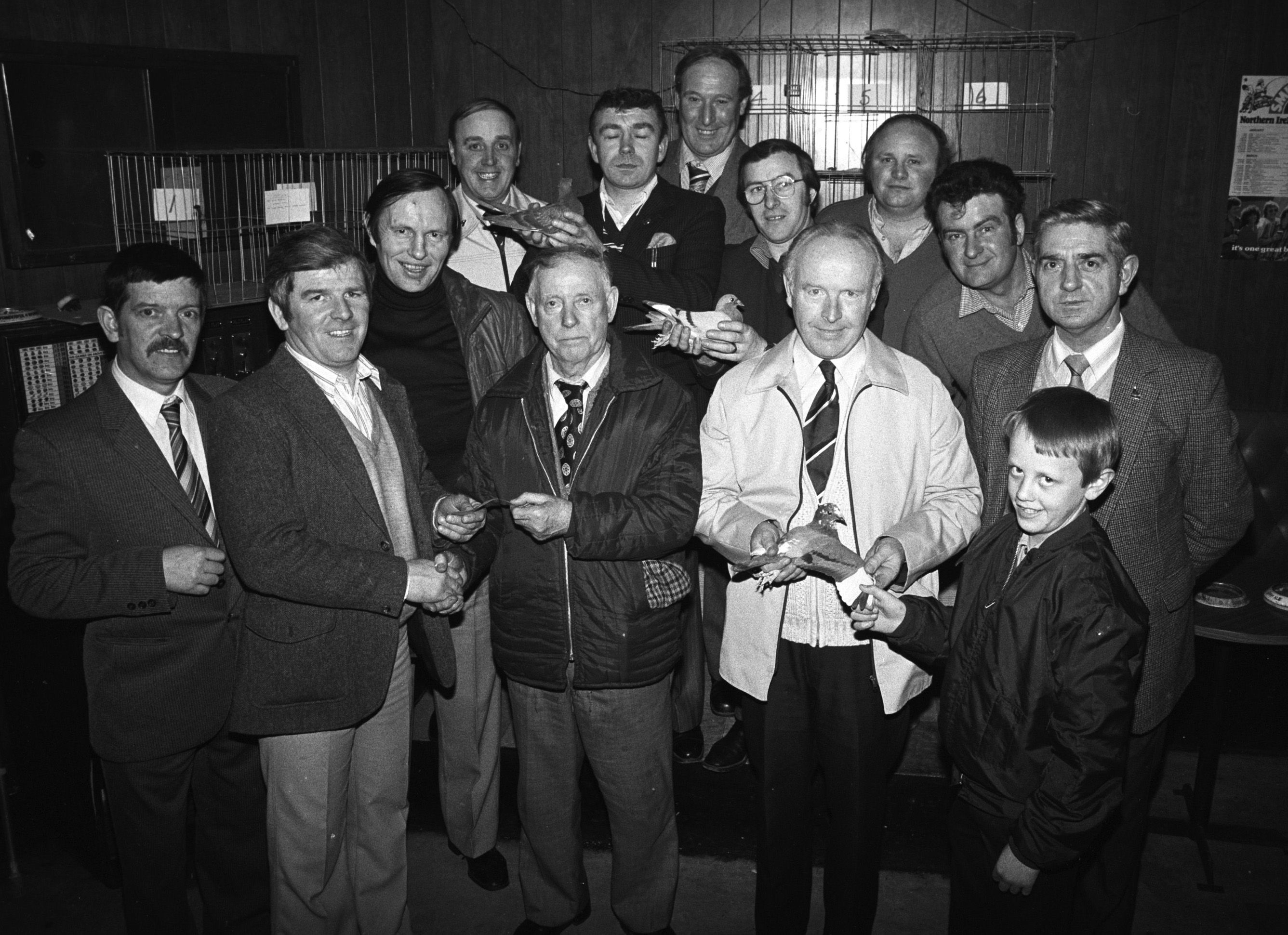 Paddy Conlon (Grosvenor Pigeon Club) presents Sean Canavan of St Agnes' ABC with money raised from bird sales. Also pictured are Jim McCourt, John Patterson, Gerry O'Prey, Mickey Smith, Geordie Devine, Billy Carson, Charlie McEvoy, Ken Rosbotham, Ronnie Malone and Mickey Short