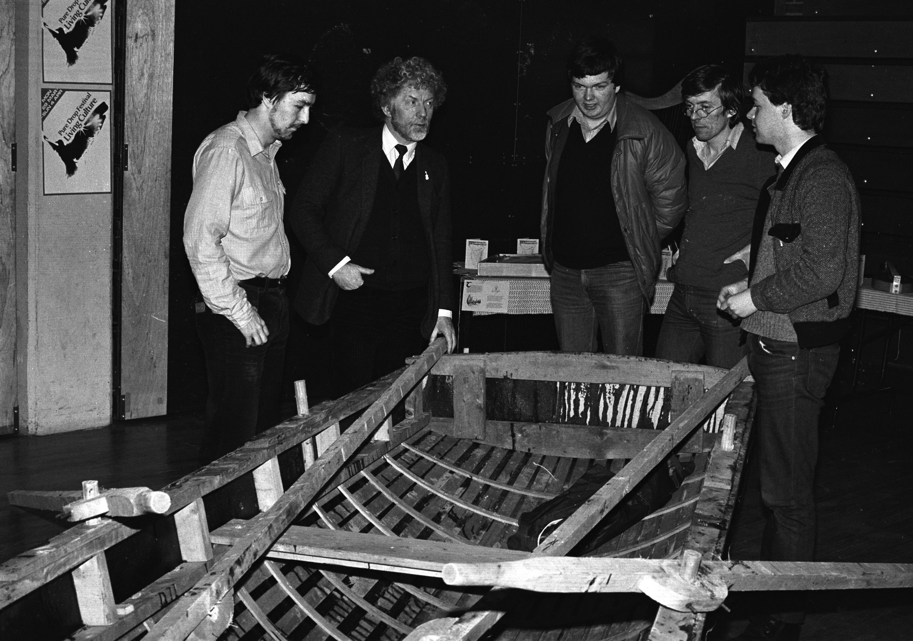 Breandan Mac Carráin, Gearóid and Tony McAuley (BBC) examine a boat in Andersonstown Leisure Centre at West Belfast Living Culture Festival