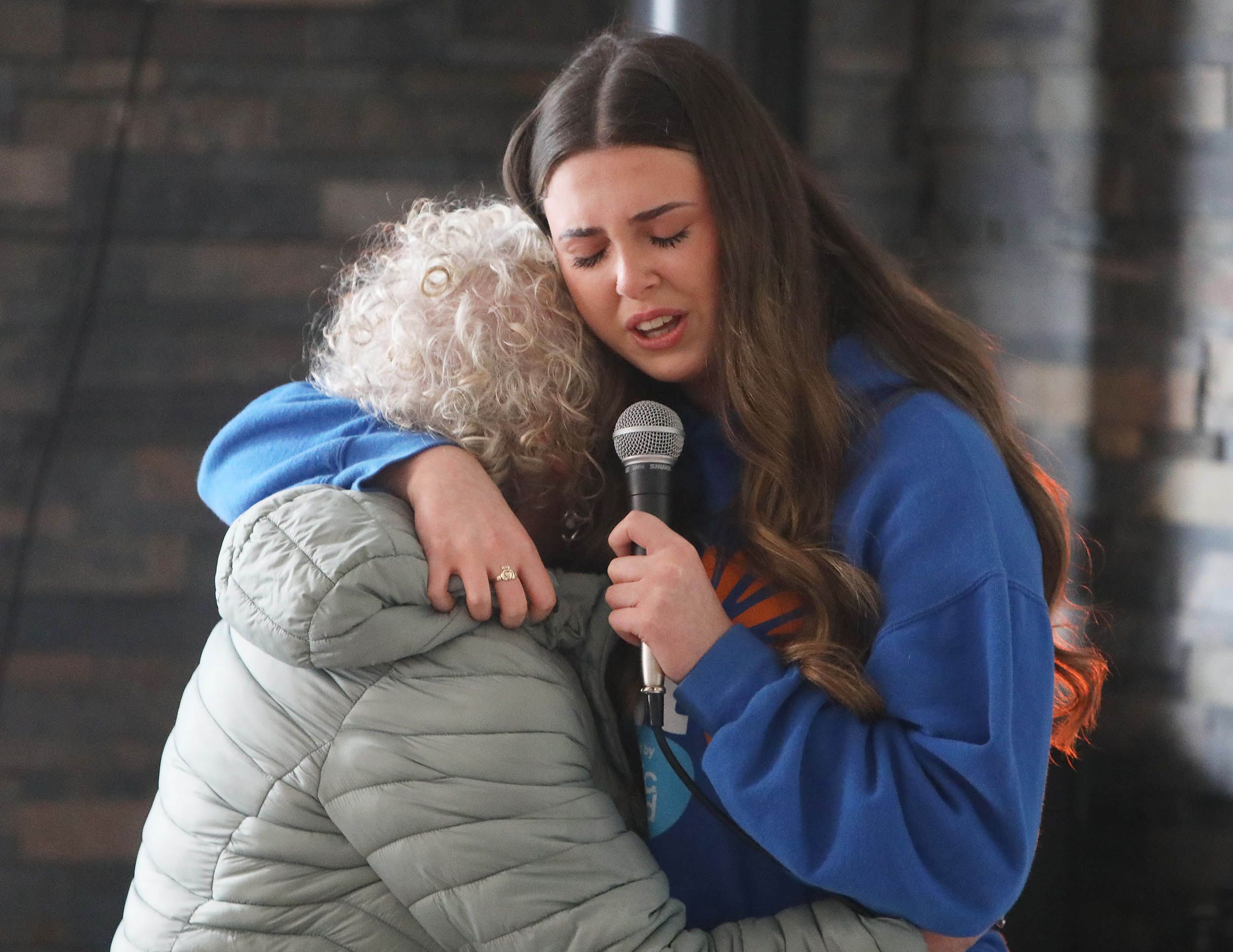 EMOTIONAL: Méabh McNeill of Lámh Dhearg was comforted by a family member after singing a powerful song encapsulating Darkness Into Light