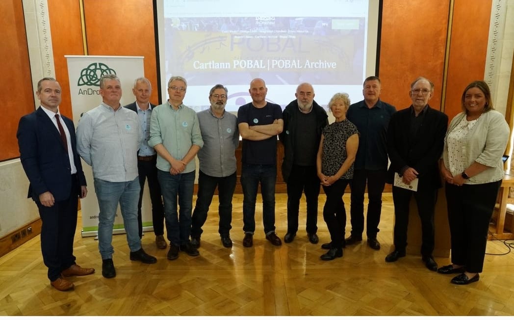 An Droichead CEO Pól Deeds, members of POBAL over the years and Deirdre Hargey MLA