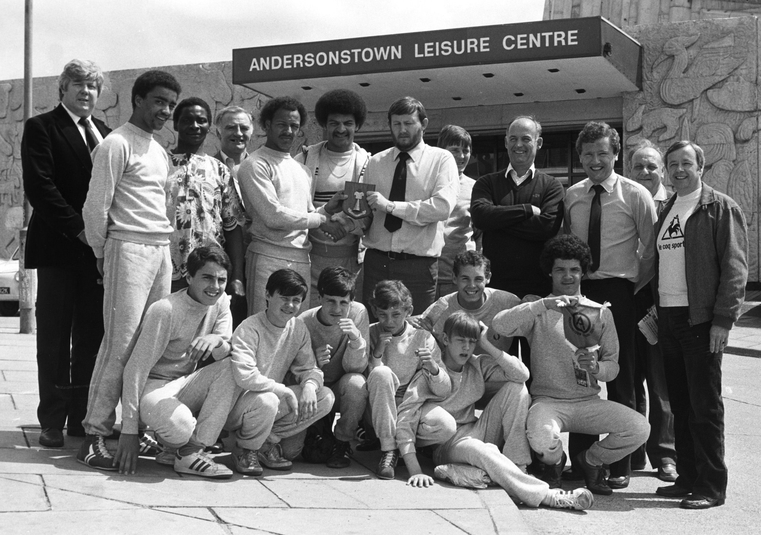 IN THE RING: Manager John Kelly gives a plaque to Owolabi of Mertyl ABC after the Belfast versus Toxteth Boxing tournament in Andersonstown Leisure Centre