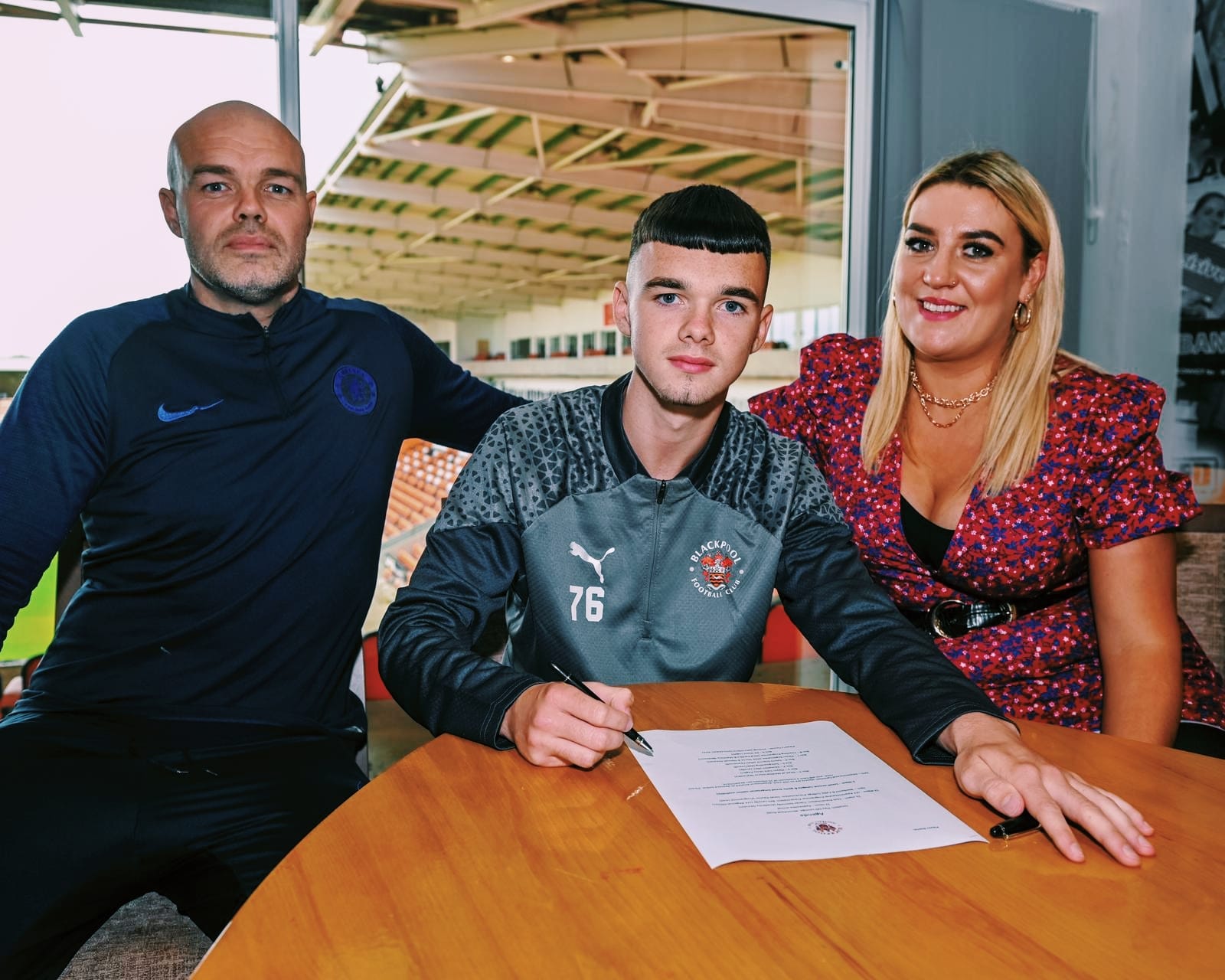 Conor McVeigh alongside his parents Conor and Trisha as he pens a three-year deal at Blackpool