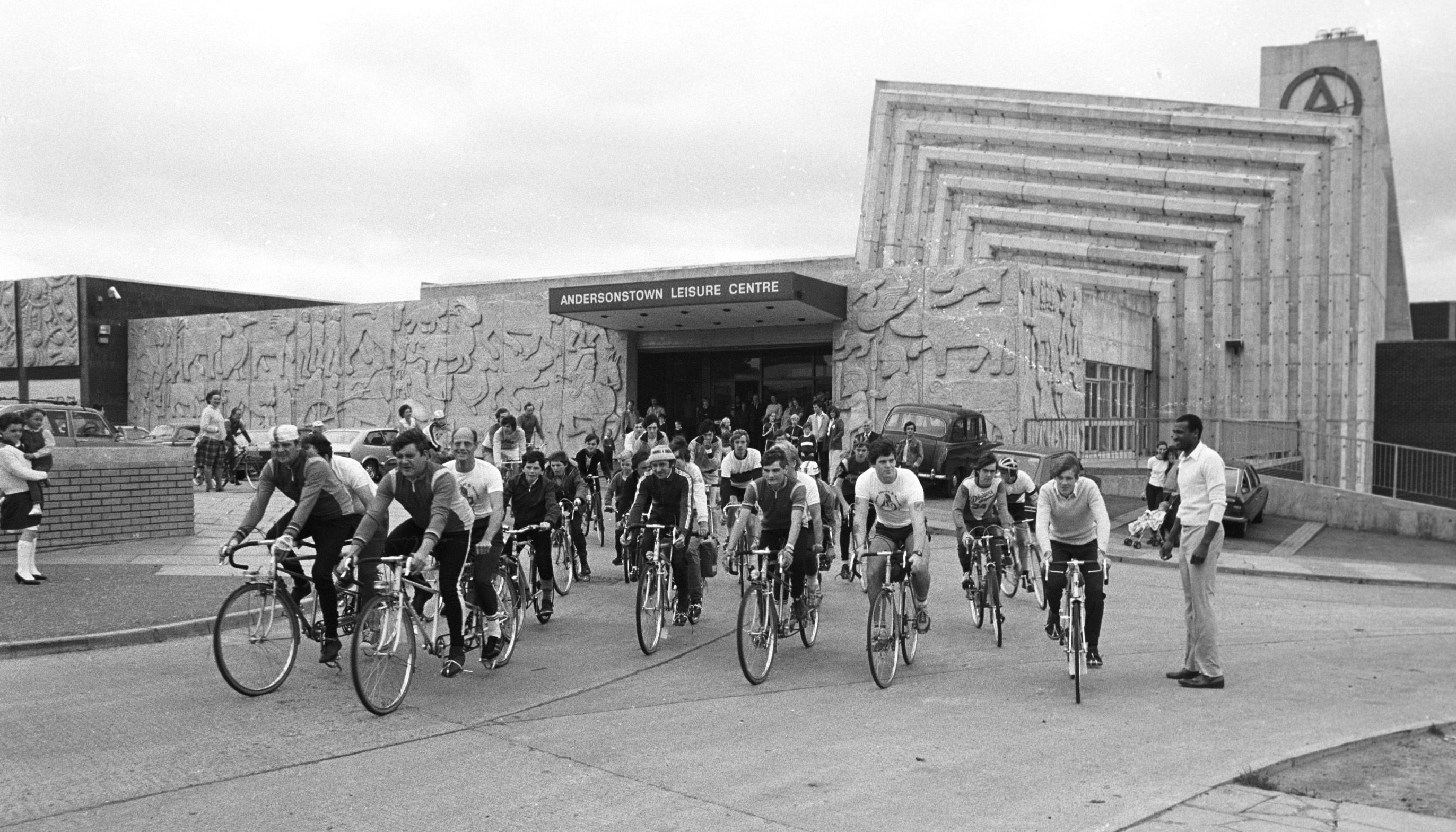 SECOND LIFE: A sponsored cycle race leaves Andersonstown Leisure Centre in 1982. The A sign can be partially seen on the chimney stack. Pic by Basil McLaughlin