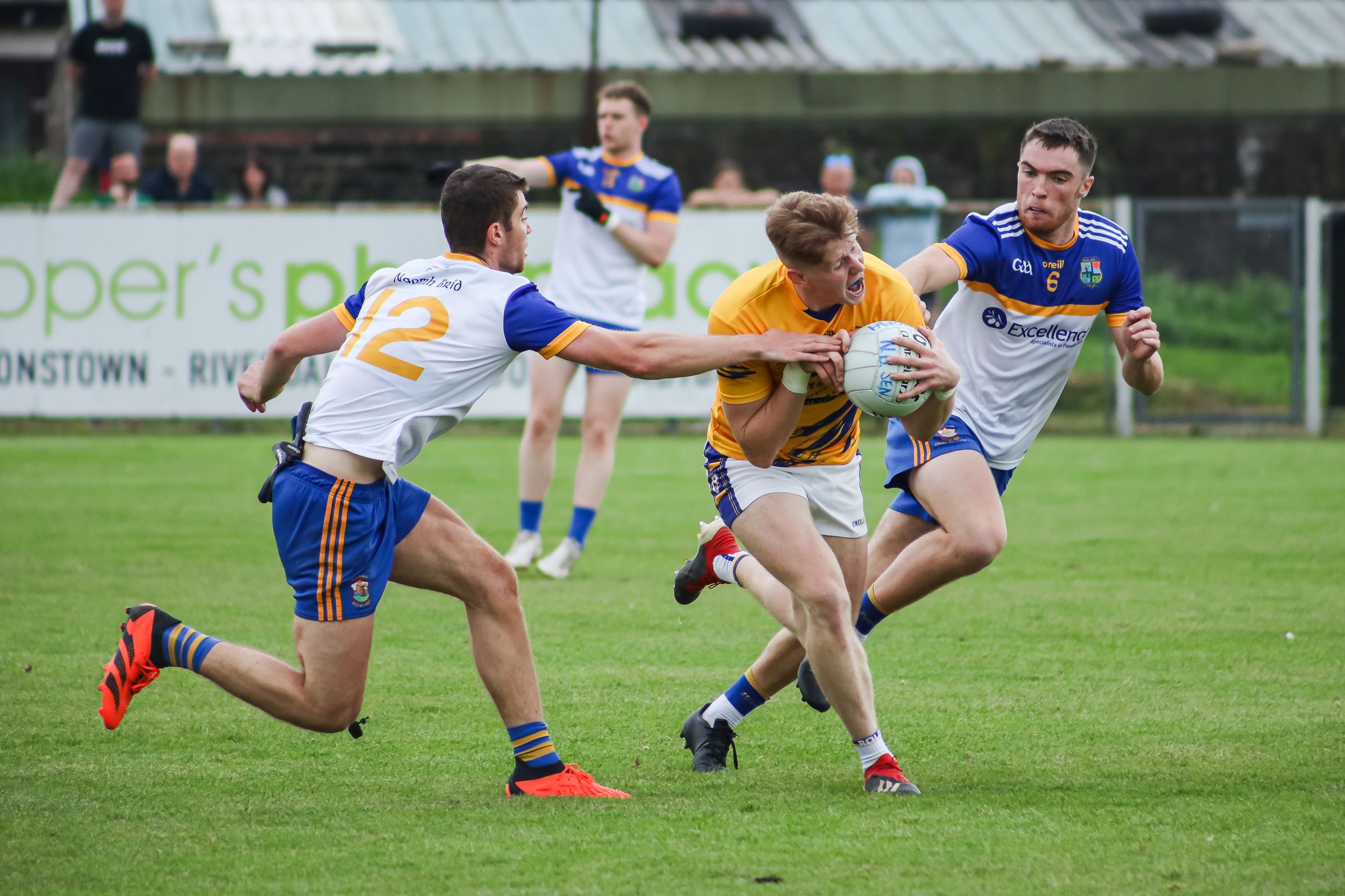 Cormac McGettigan is challenged by James Smith and Peter King 