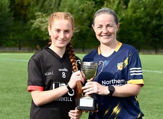Antrim manager Emma Kelly presents the trophy to Ardoyne captain, Aideen McDonnell