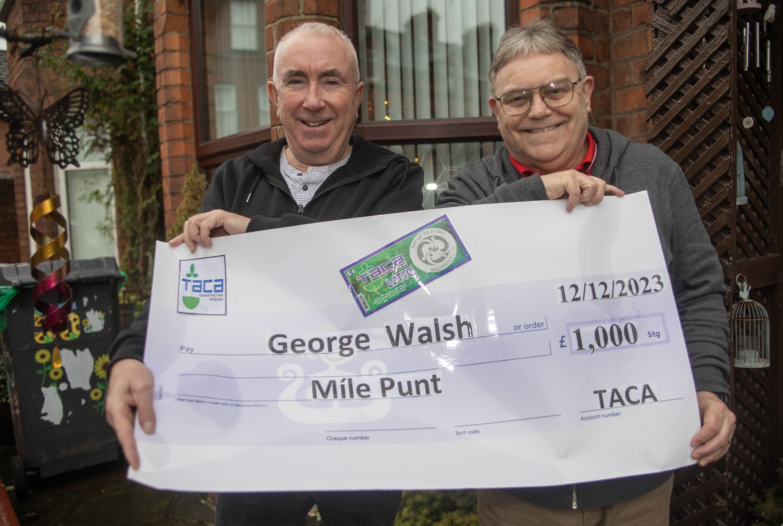 WINNER: Pádraig Ó’Cianáin of TACA with scratch card winner George Walsh in December