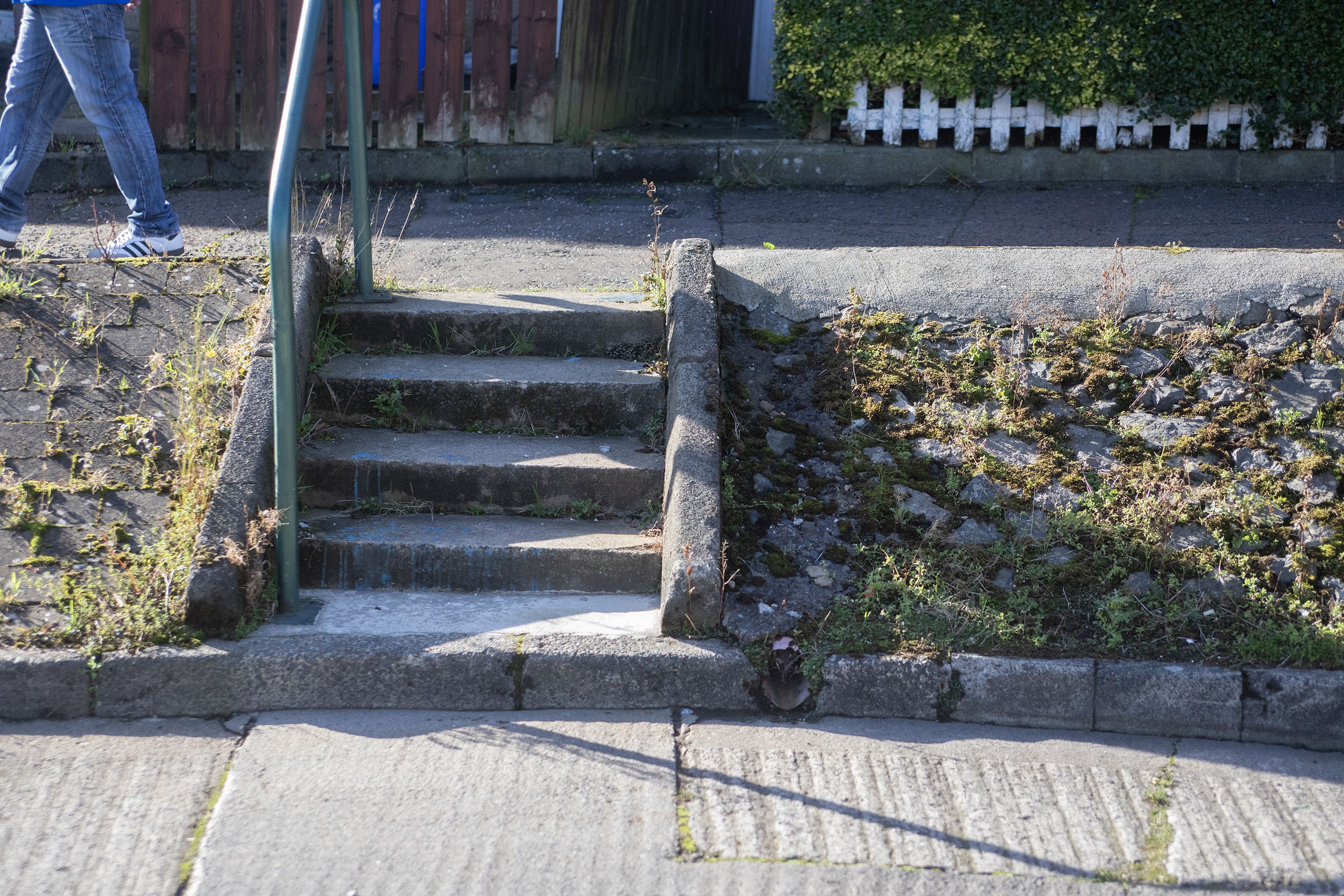 Stoned slopes throughout Turf Lodge could be removed to widen the streets