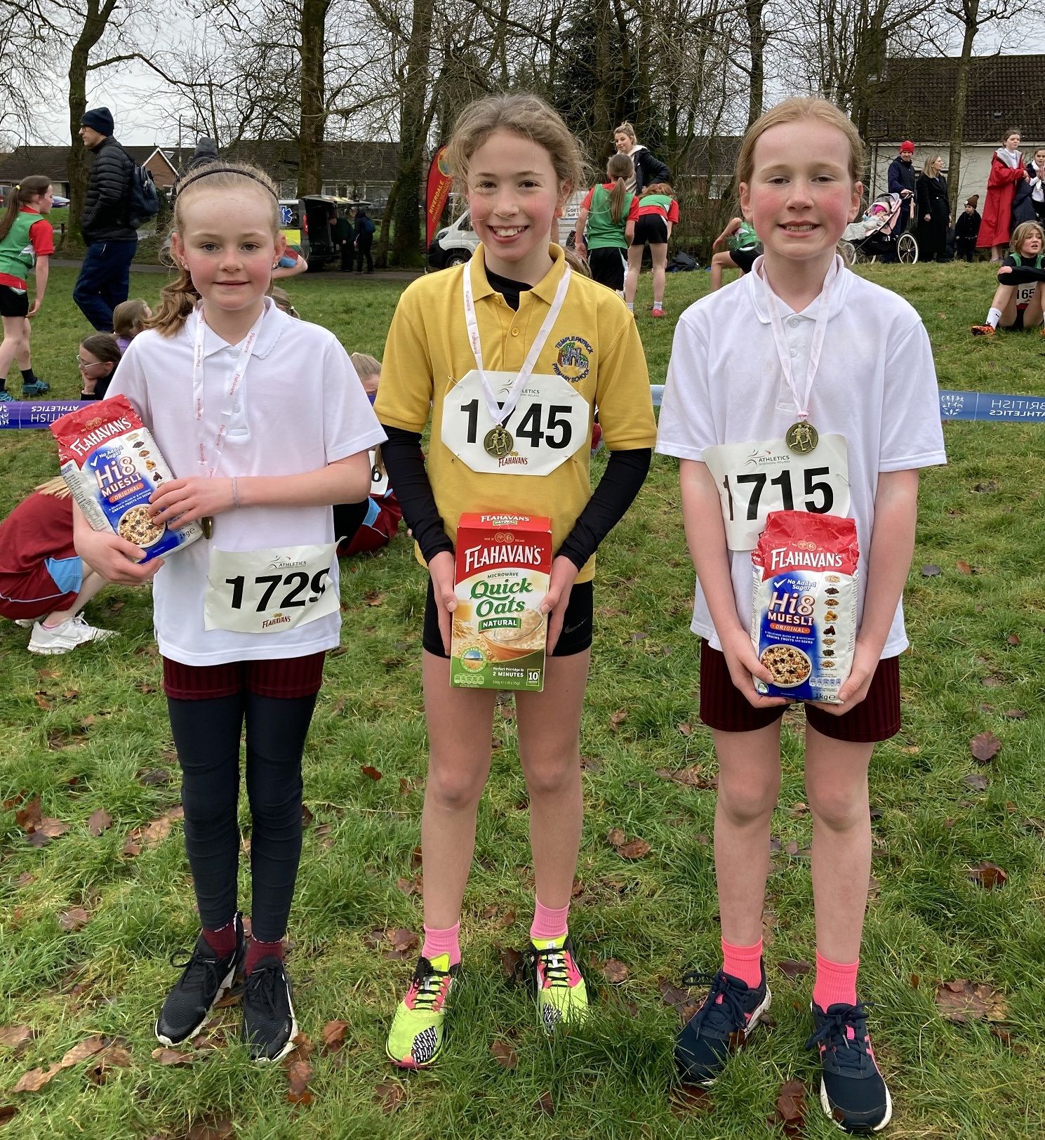 Emma Carson in second place, Kiyomi Tosh in first place and Orla Kelly in third place in second the girls’ race