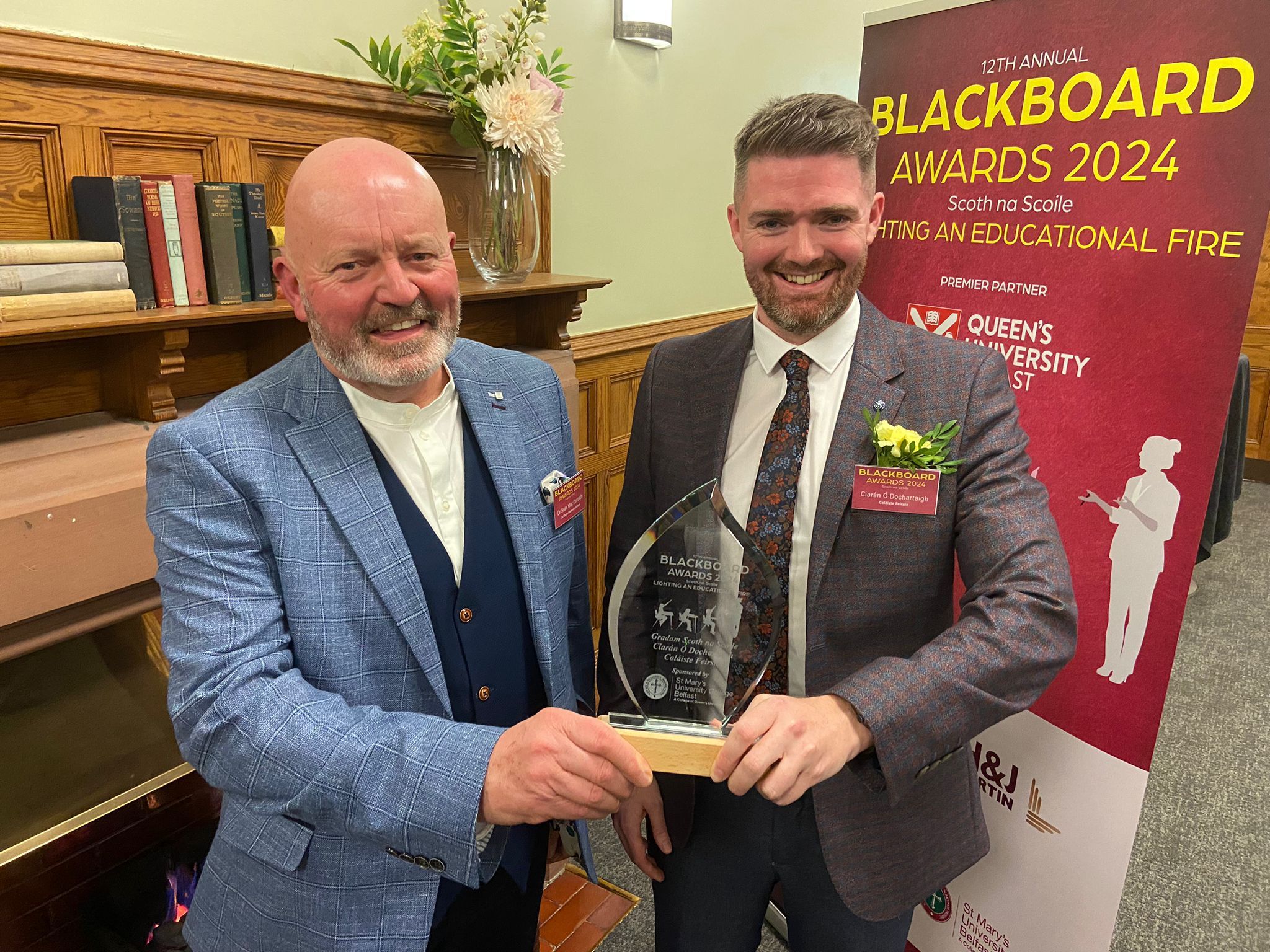 MOLADH MÓR: Seán Mac Corraidh of St Mary's University College presents the award for teacher in an Irish Medium School who made the greatest community impact to Coláiste Feirste teacher Ciarán Ó Dochartaigh