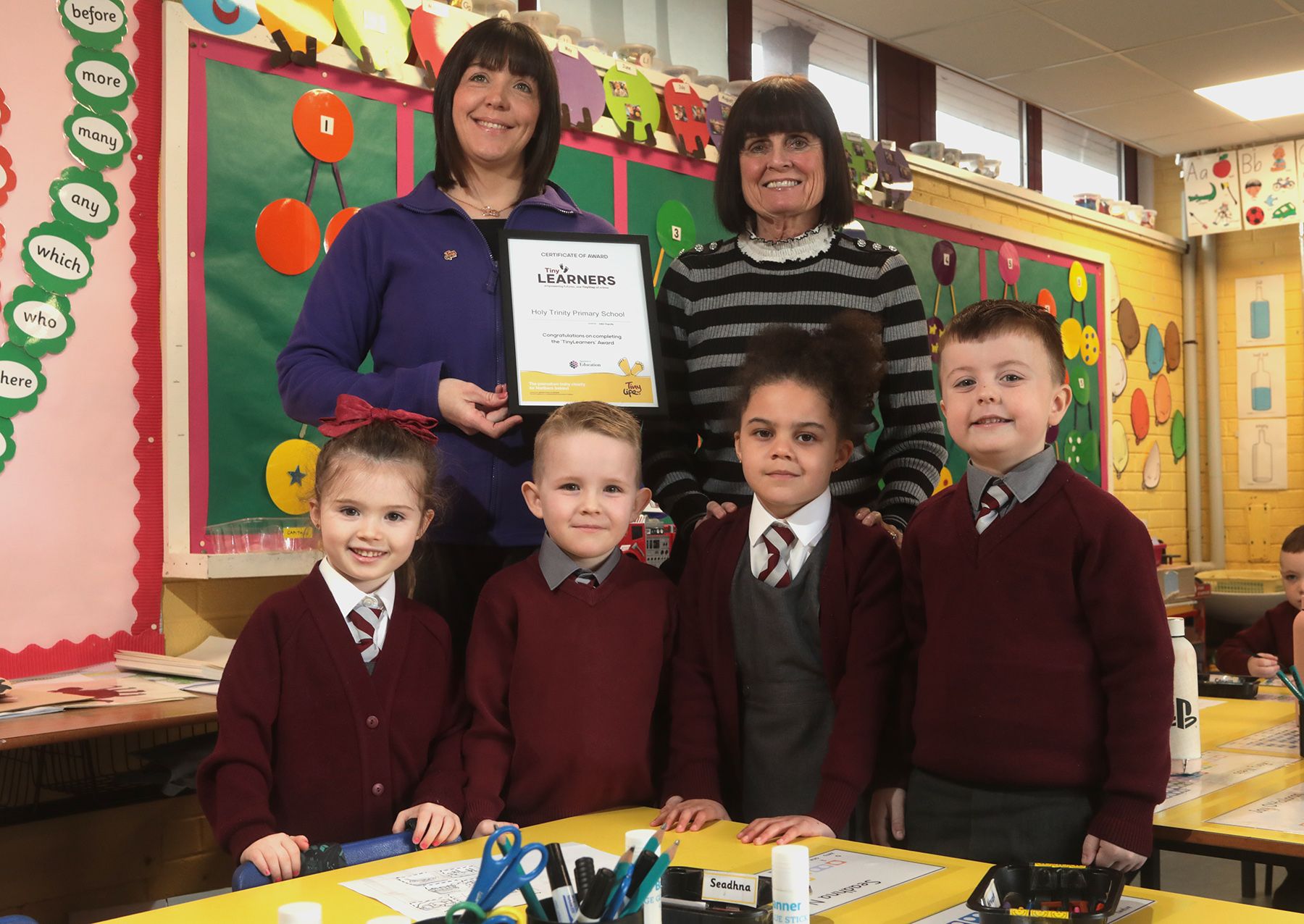 Principal Fiona Boyd and Catherine Black from Tiny Life with pupils Amelia, Seadhna, Nevaeh and Jay