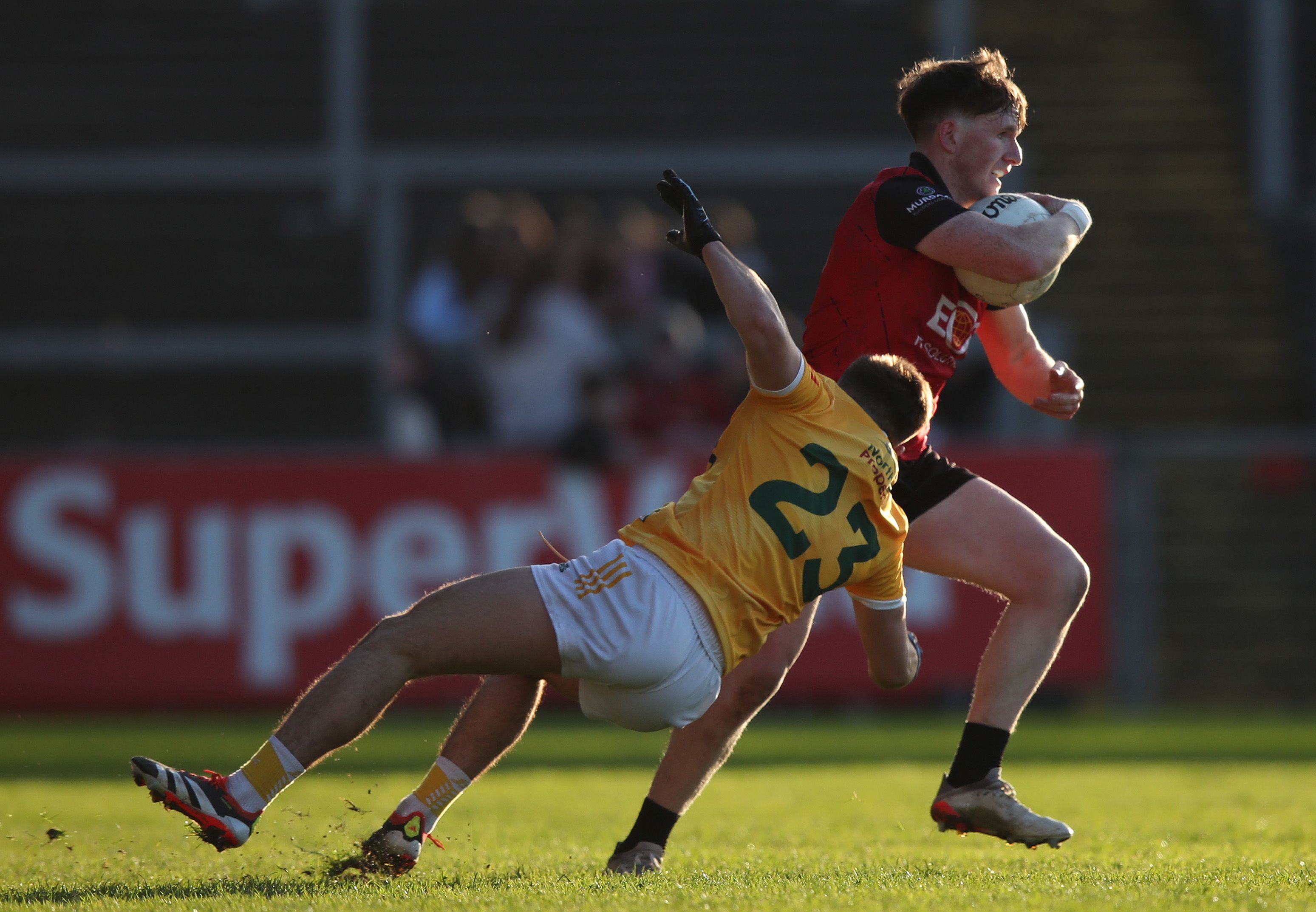 Antrim's Niall Burns tackles Miceal Rooney of Down