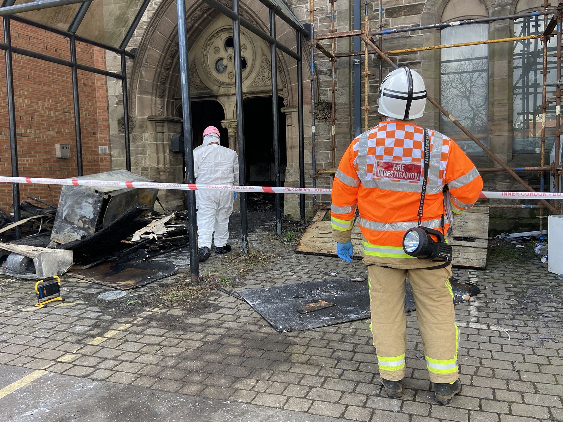 ARSON: Police and Fire Service investigators at the gutted Donegall Pass multicultural centre in 2022