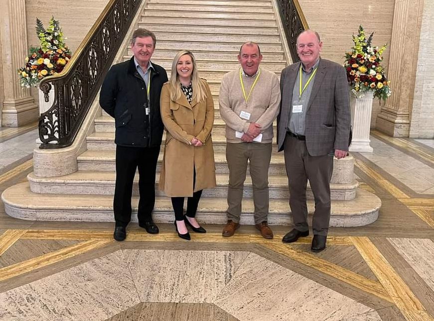 Órlaithí Flynn MLA and Cllr Arder Carson with Jim Ferguson and Johnny McQuillan of the Hannastown Residents' Association at Stormont