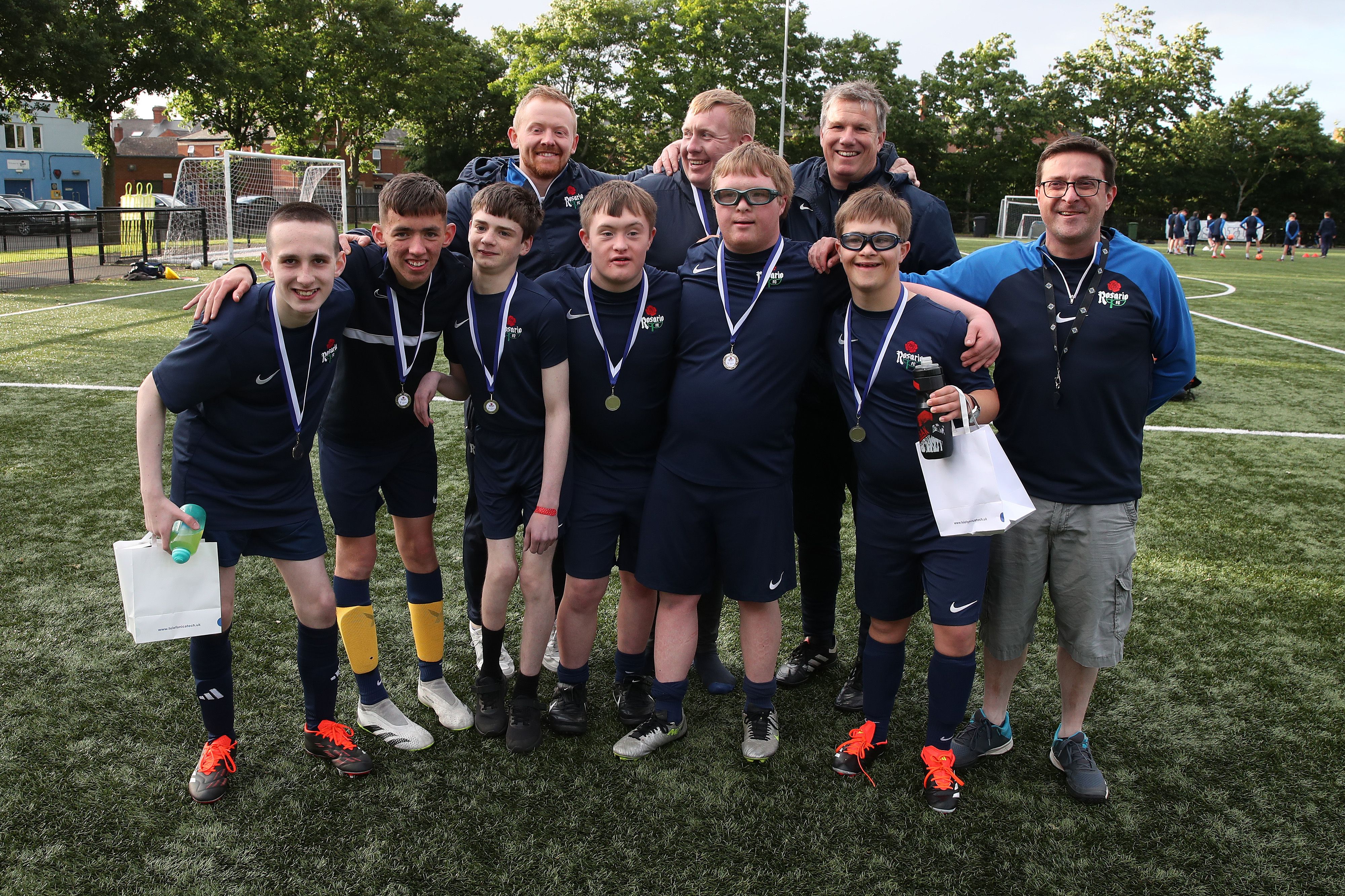 Peter Leonard alongside fellow Football Coaches at Rosario and a number of members following their prize-giving celebration.