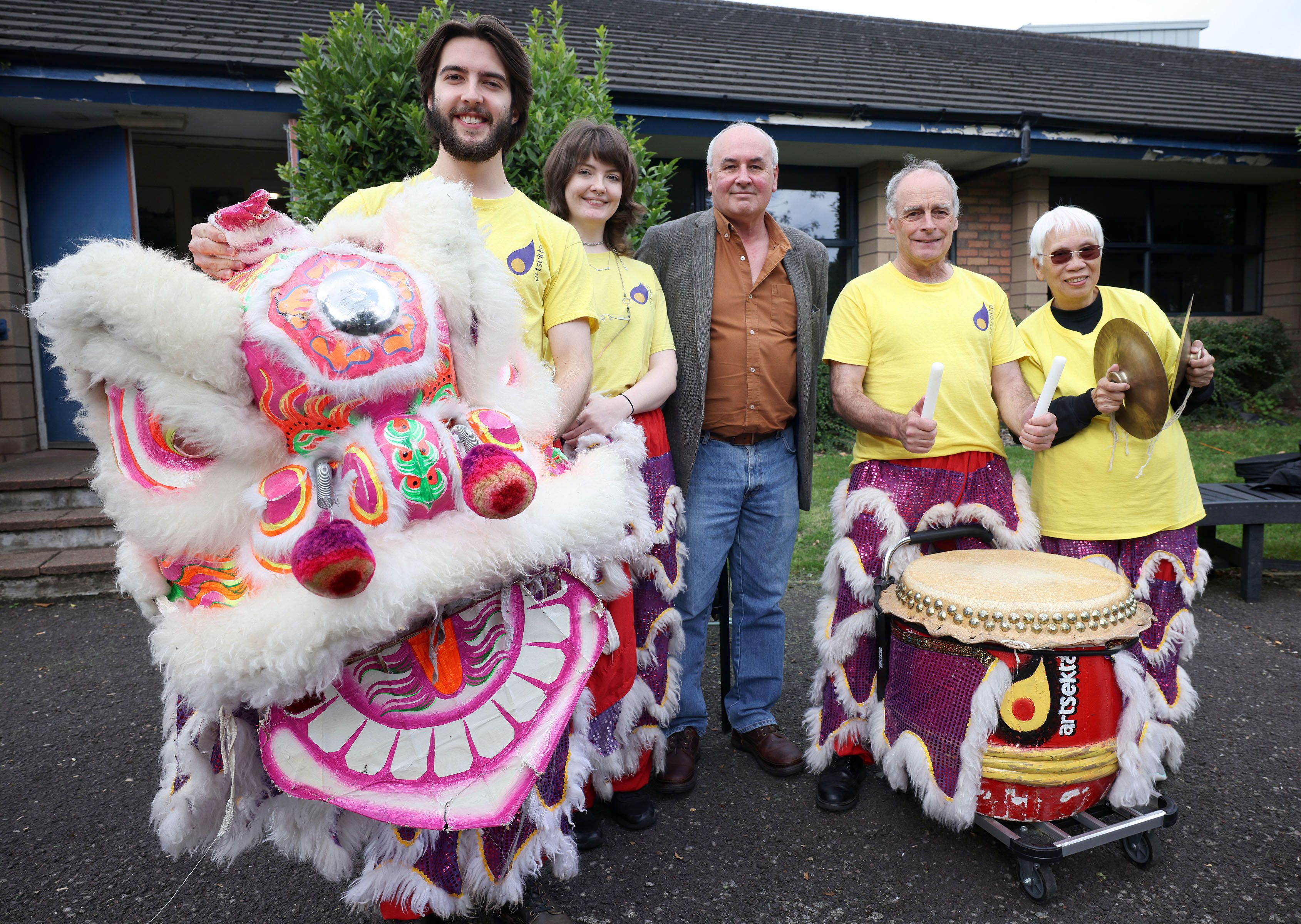 Dr Sean Brennan, Good Relations Officer, Housing Executive, with some of the performers at the Ligoniel multi-cultural festival
