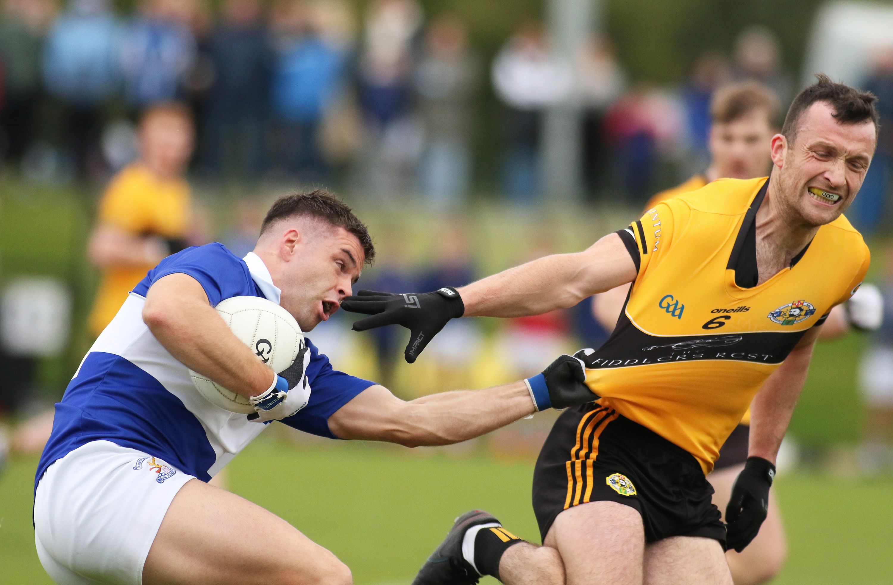Patrick McBride tests the strength of Dermott McAleese's jersey