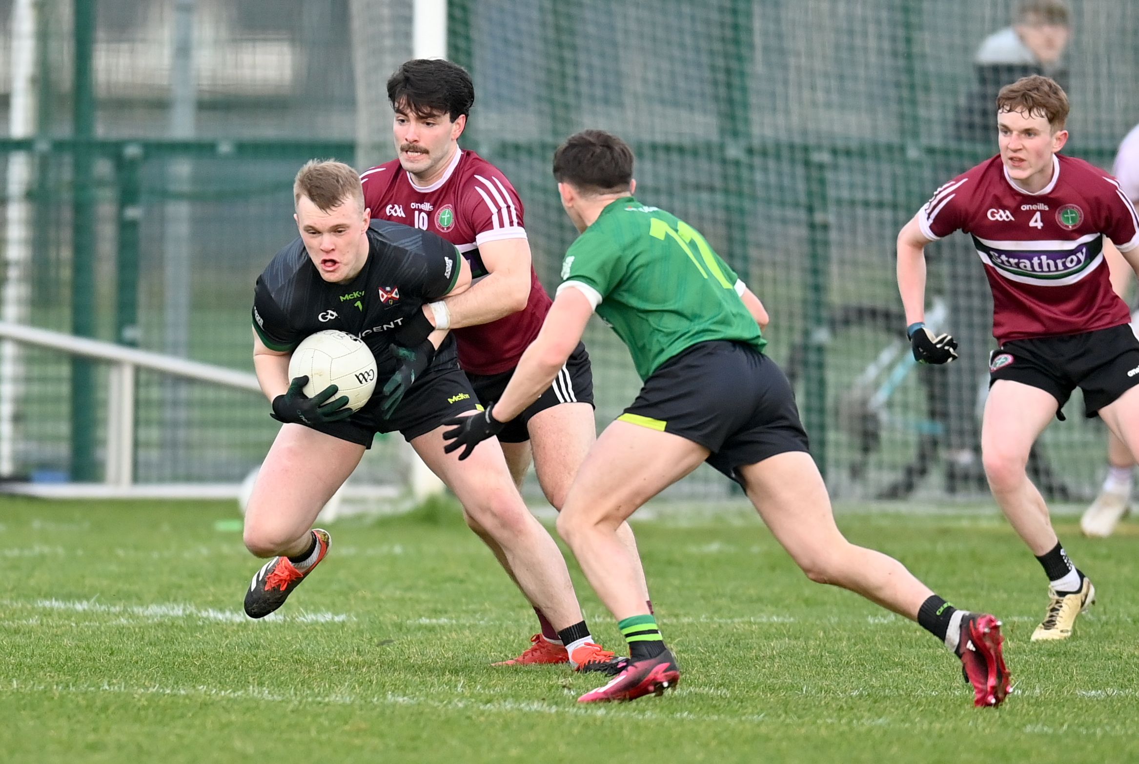QUB goalkeeper Oran McGrath comes under pressure from Dara Mooney 