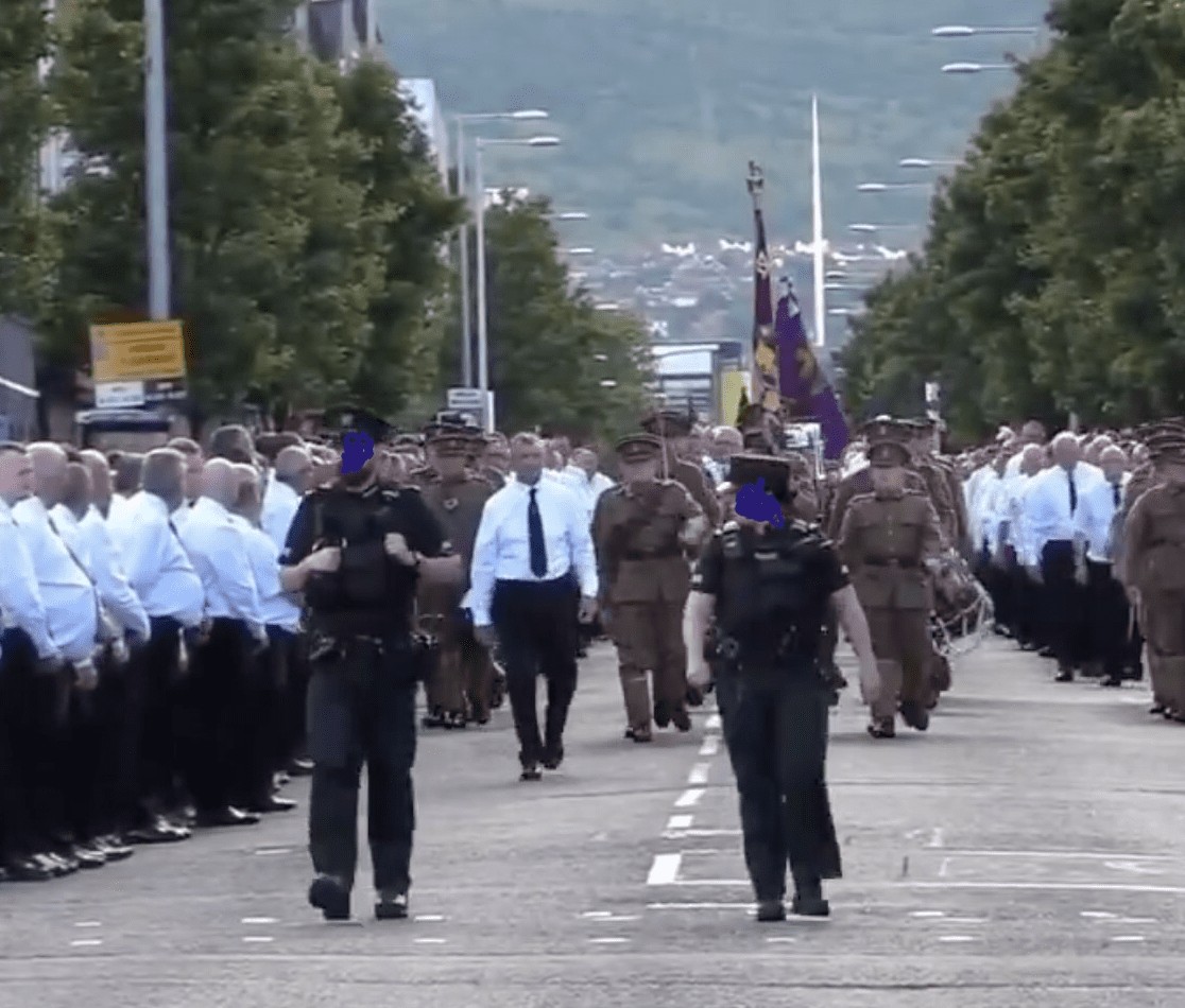 ESCORT: PSNI officers at the head of a UVF show of strength in East Belfast in June 2024