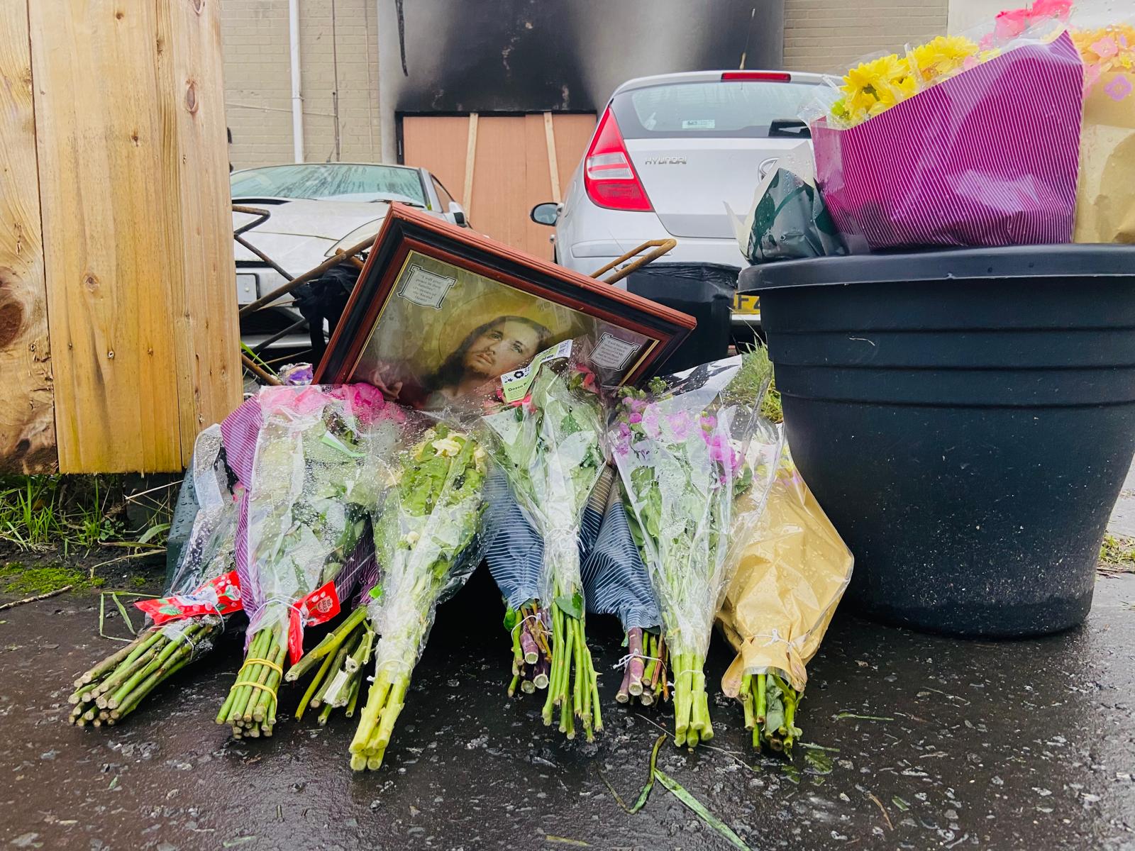 Floral tributes outside the house in Areema