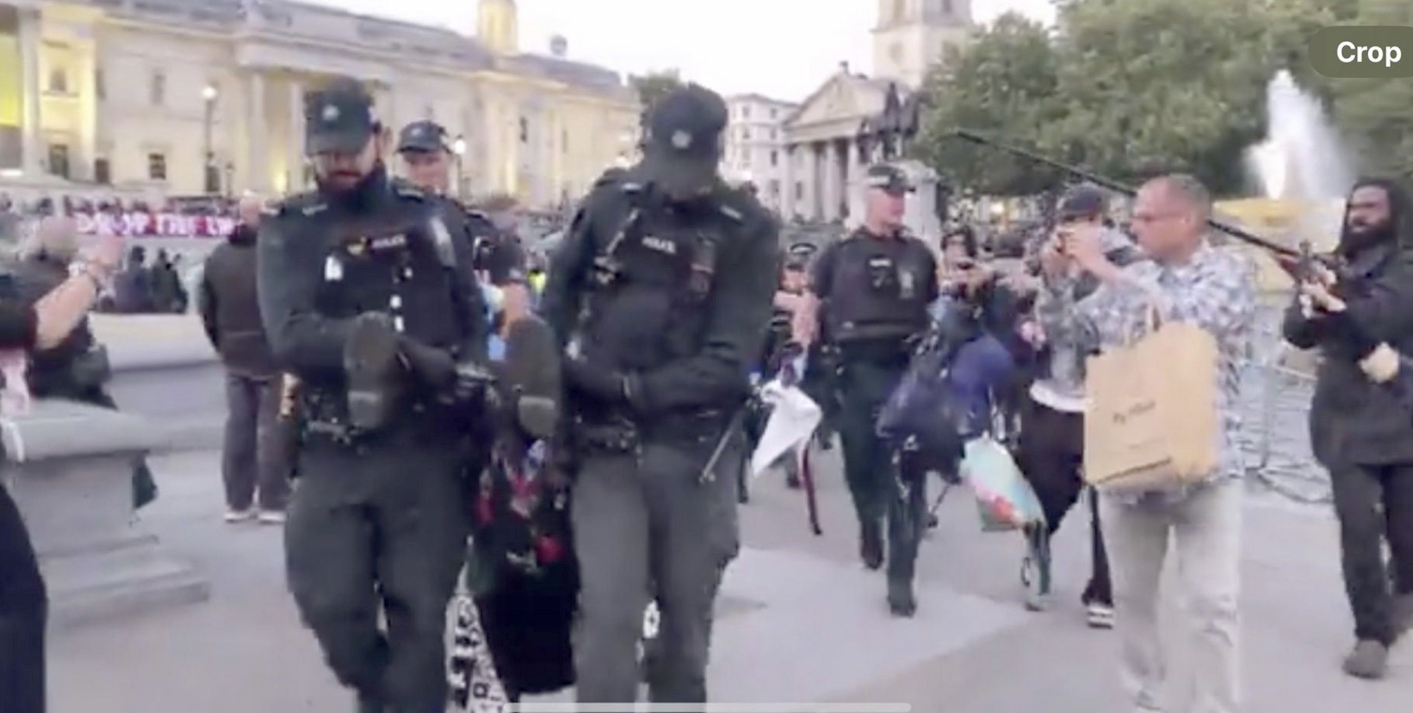 MOBILE UNIT: PSNI officers arresting an elderly protester in Trafalgar Square