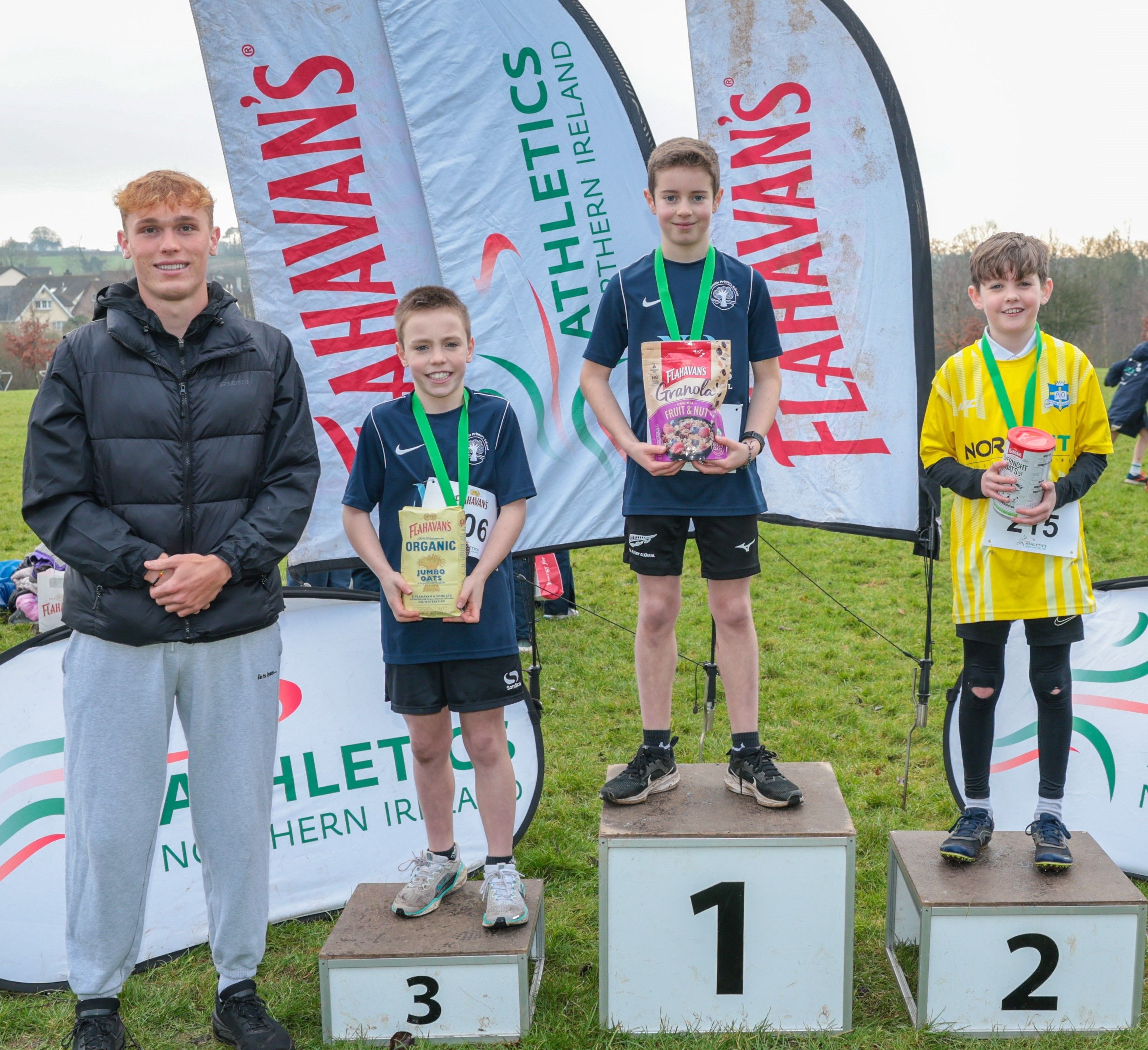 (L-R): Callum Baird, Athletics NI and Flahavan’s League Ambassador, Isaac Mooney from Our Lady of Lourdes (second), Hugo Lowry from Stranmillis Primary School (first), and Eimhin Bourke from Stranmillis Primary School (third) 