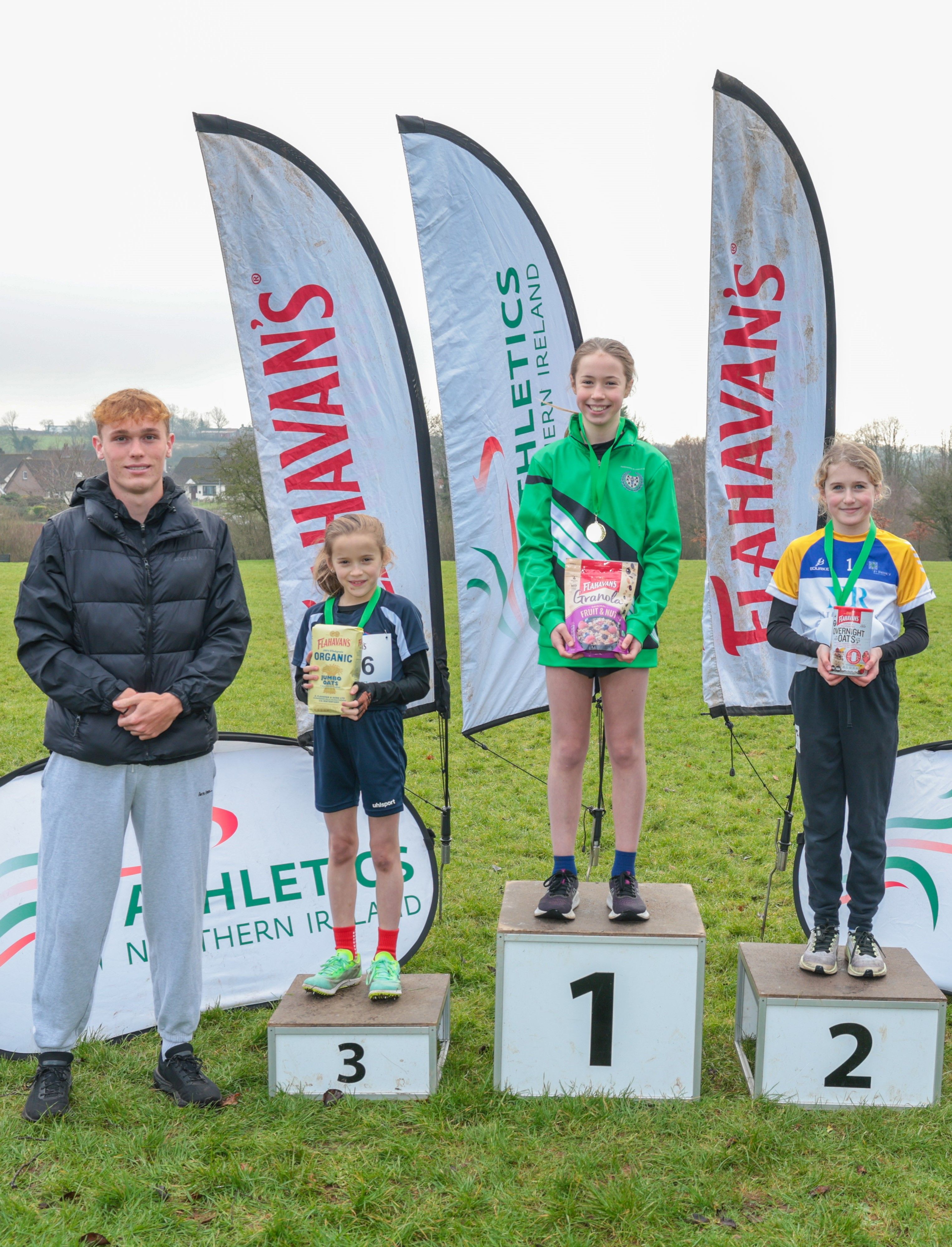 (L-R): Callum Baird, Athletics NI and Flahavan’s League Ambassador, Sarah Jackson from St Bride’s Primary School (second), Kiyomi Tosh from Templepatrick Primary School (first), and Rose Millar from St Mary’s Primary School (third) 