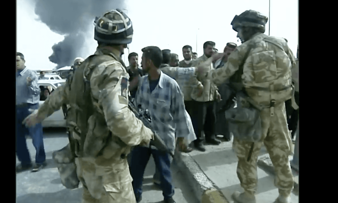 LIE OF THE LAND: US troops with Iraqi civilians in Baghdad in 2003