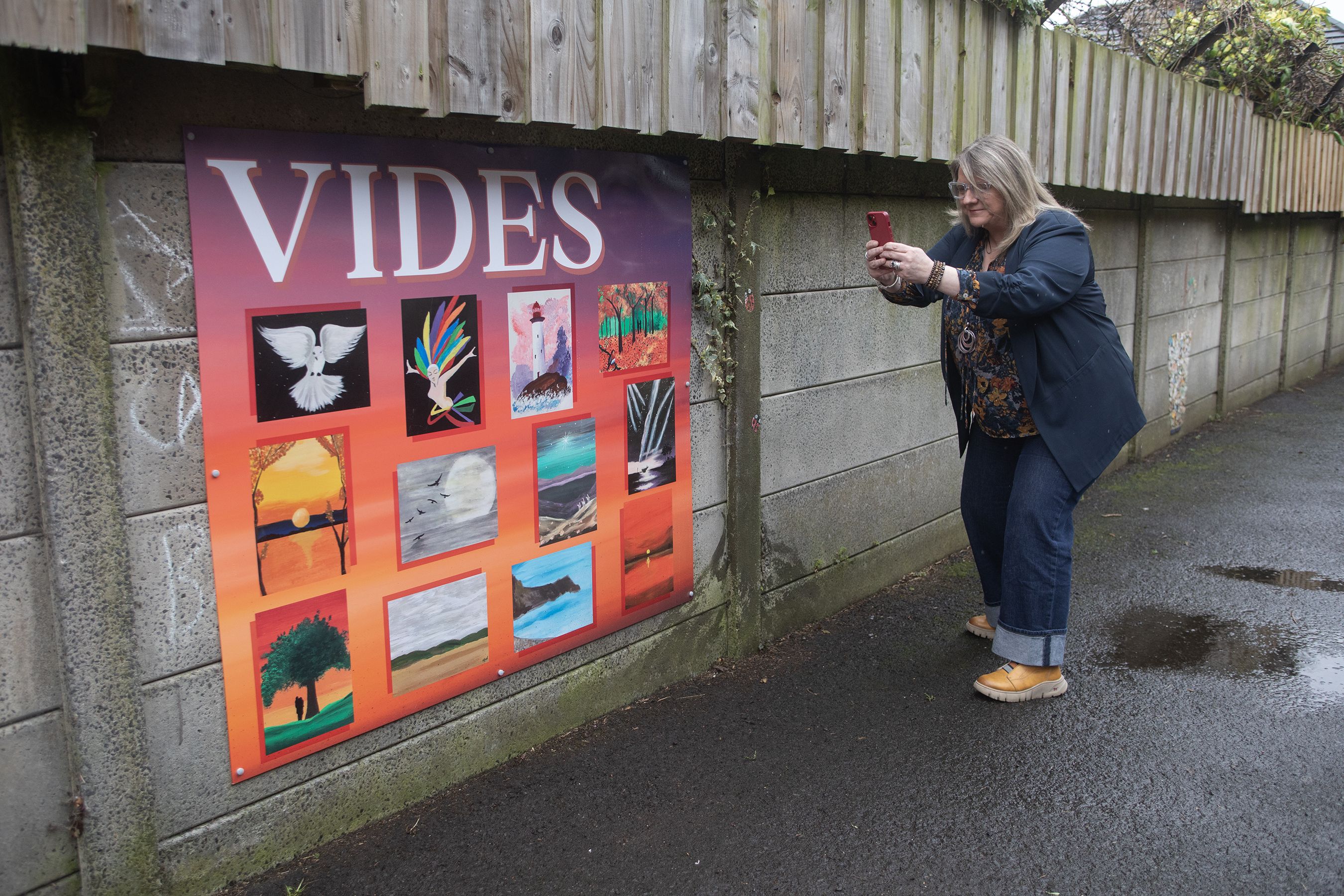 Rev. Karen Sethuraman takes a snap of the mural