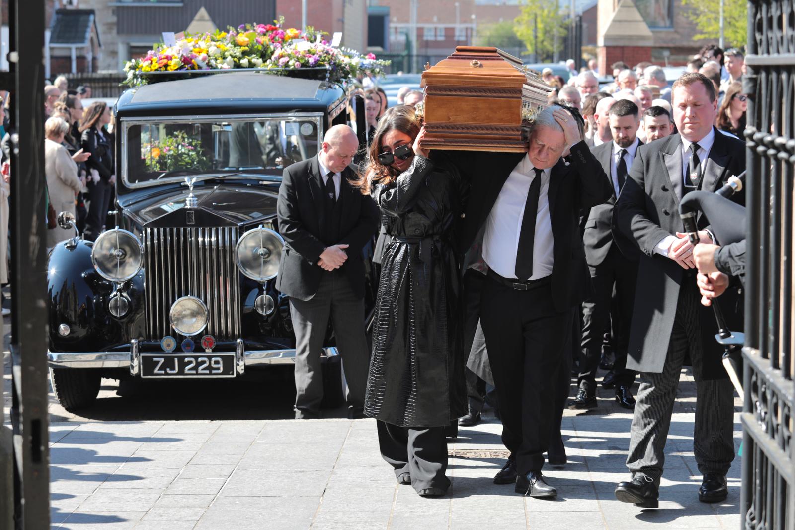 Bernie Adams' coffin is carried by her husband Dougie yesterday