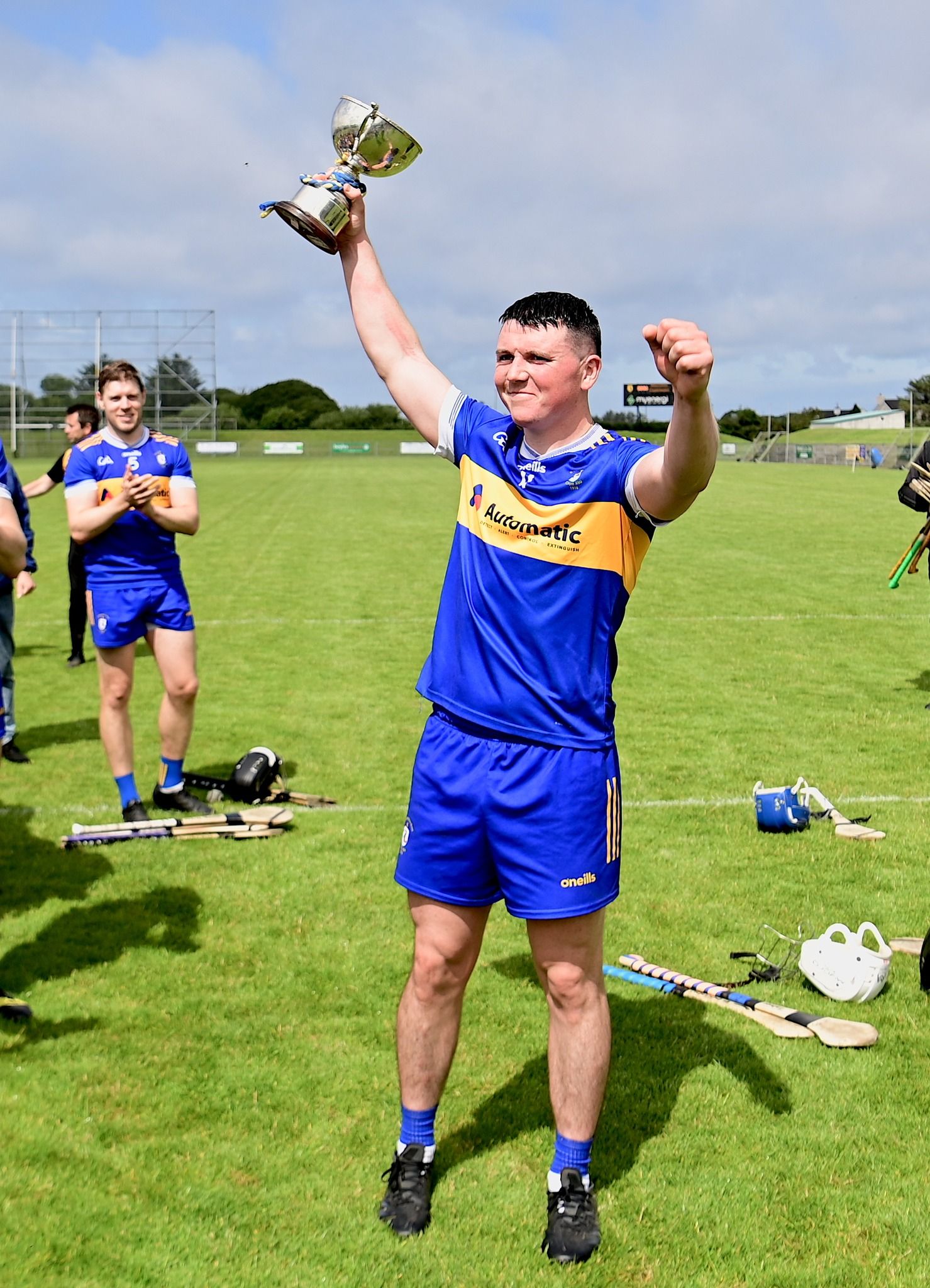 CHAMPIONS: Rossa captain Declan McCartney hoists the league title high