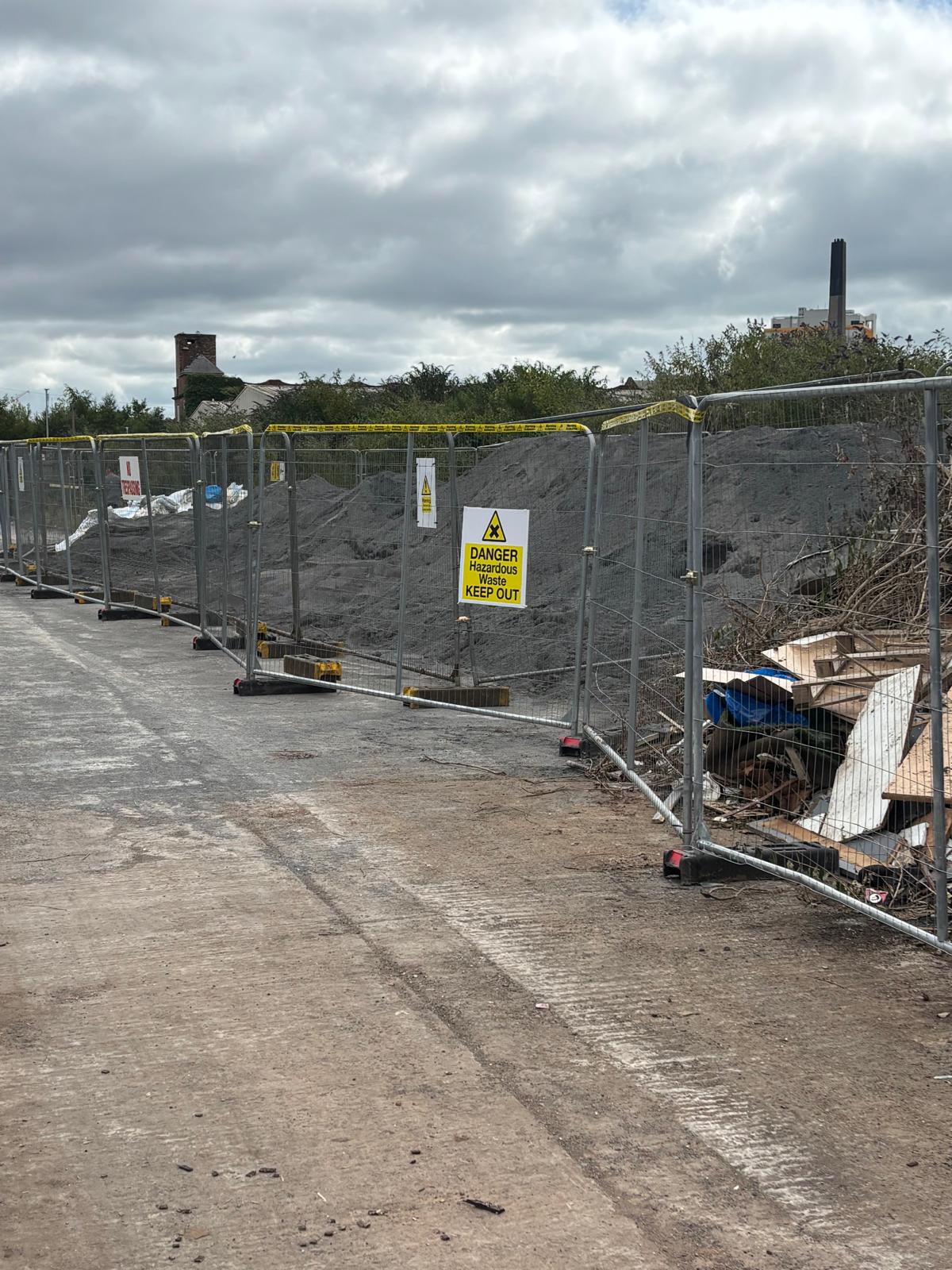 The asbestos facing the bonfire is covered in gravel