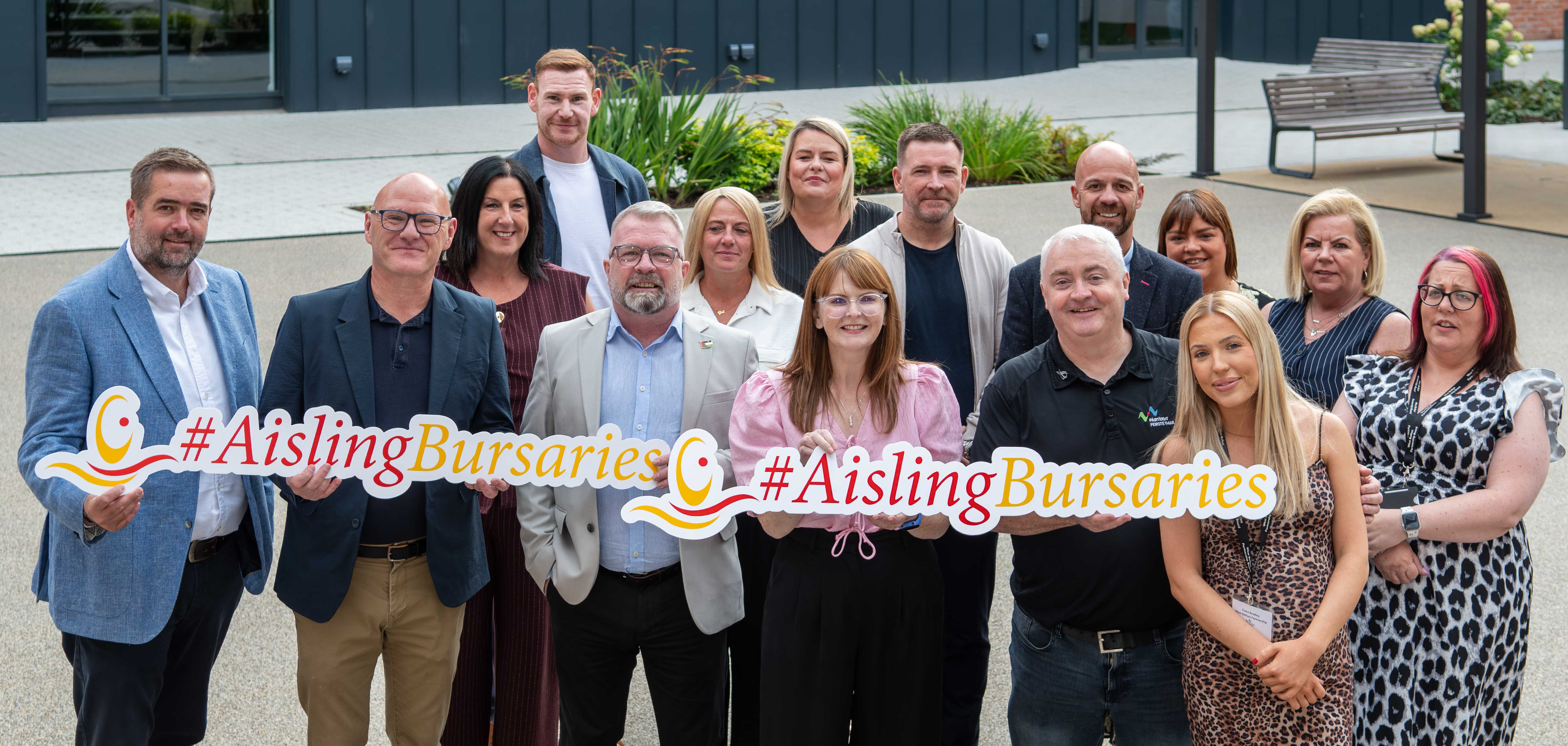 Staff from West Belfast Partnership Board with Paul Maskey MP and Economy Minister Caoimhe Archibald 