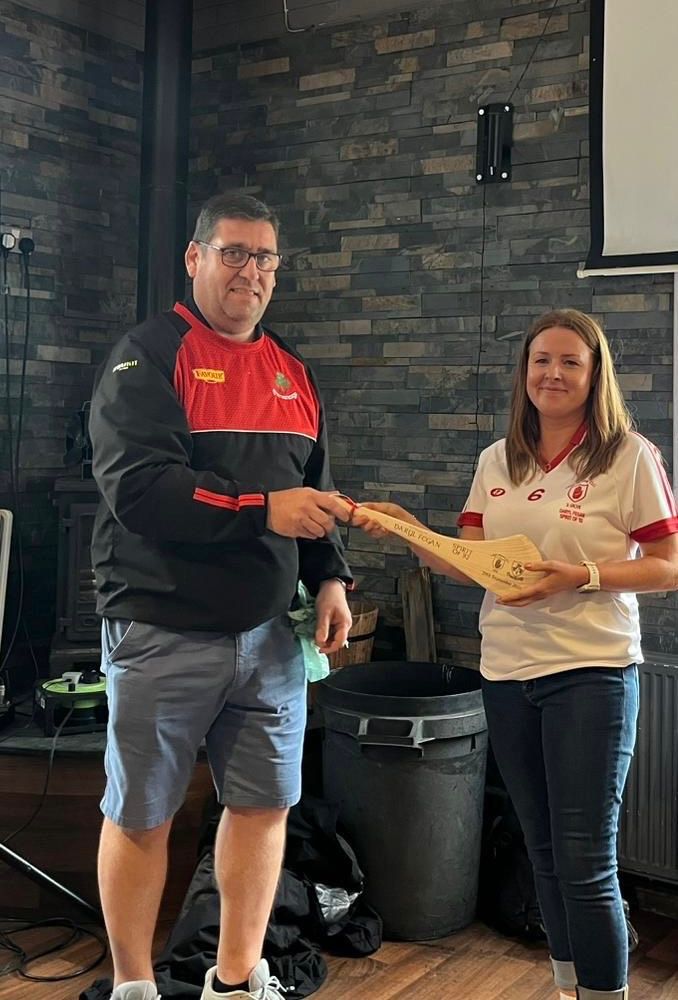 PJ Mullan presents Sarah Fegan with a memorial hurl