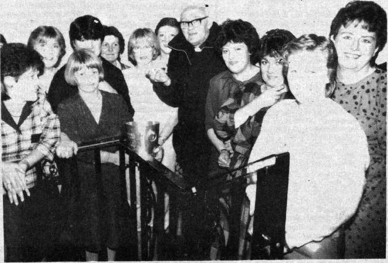 ALL ABORD: Fr Liam Mullan, Parish Priest of St Luke's made the draw for the ballot at the Bridini Parents' Night disco in the Hitchin' Post. The committee were raising money for a minibus