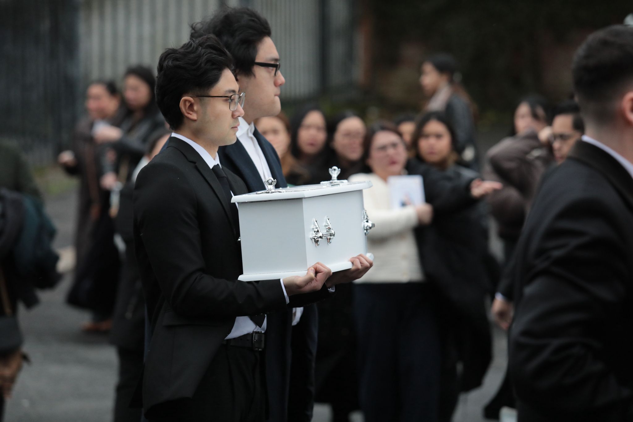 Mourners carrying the coffin of baby Kate