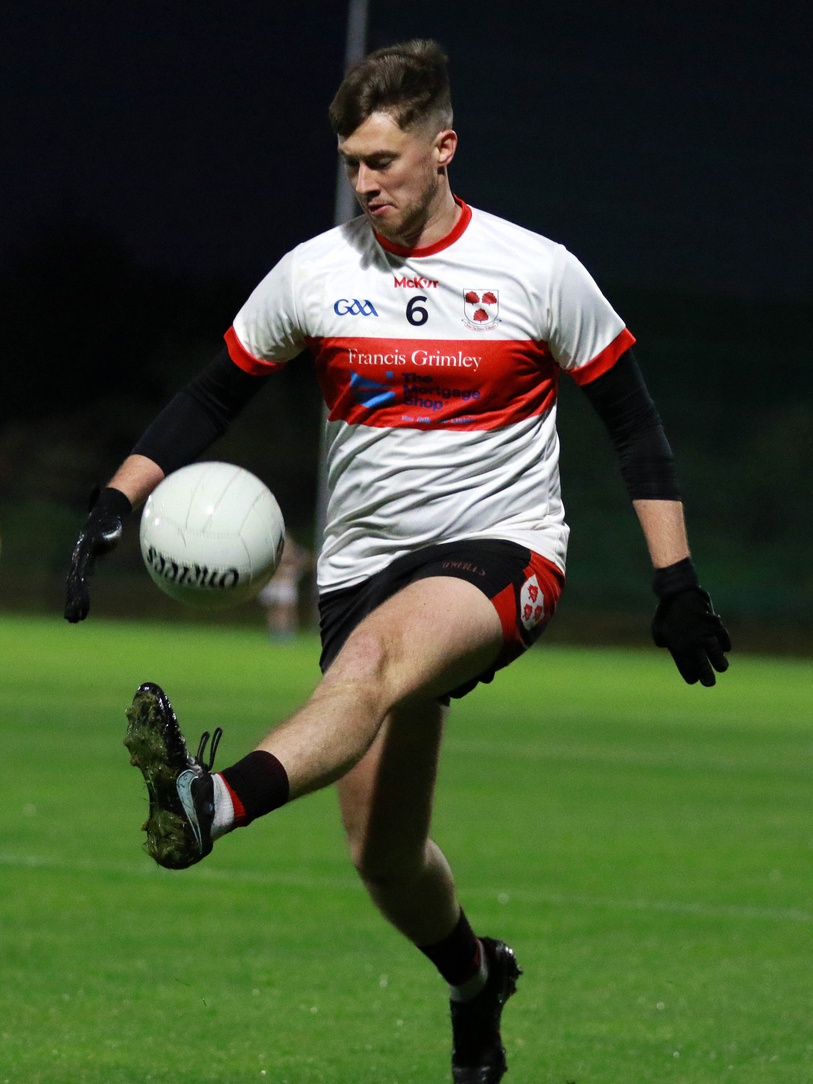 Stephen Erskine solos the ball out for Éire Óg