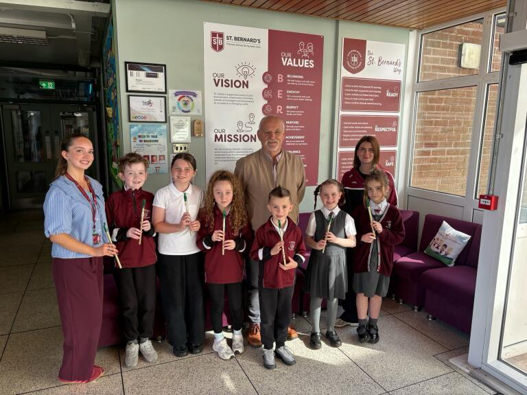 Ray Morgan with pupils and staff from St Bernard's PS