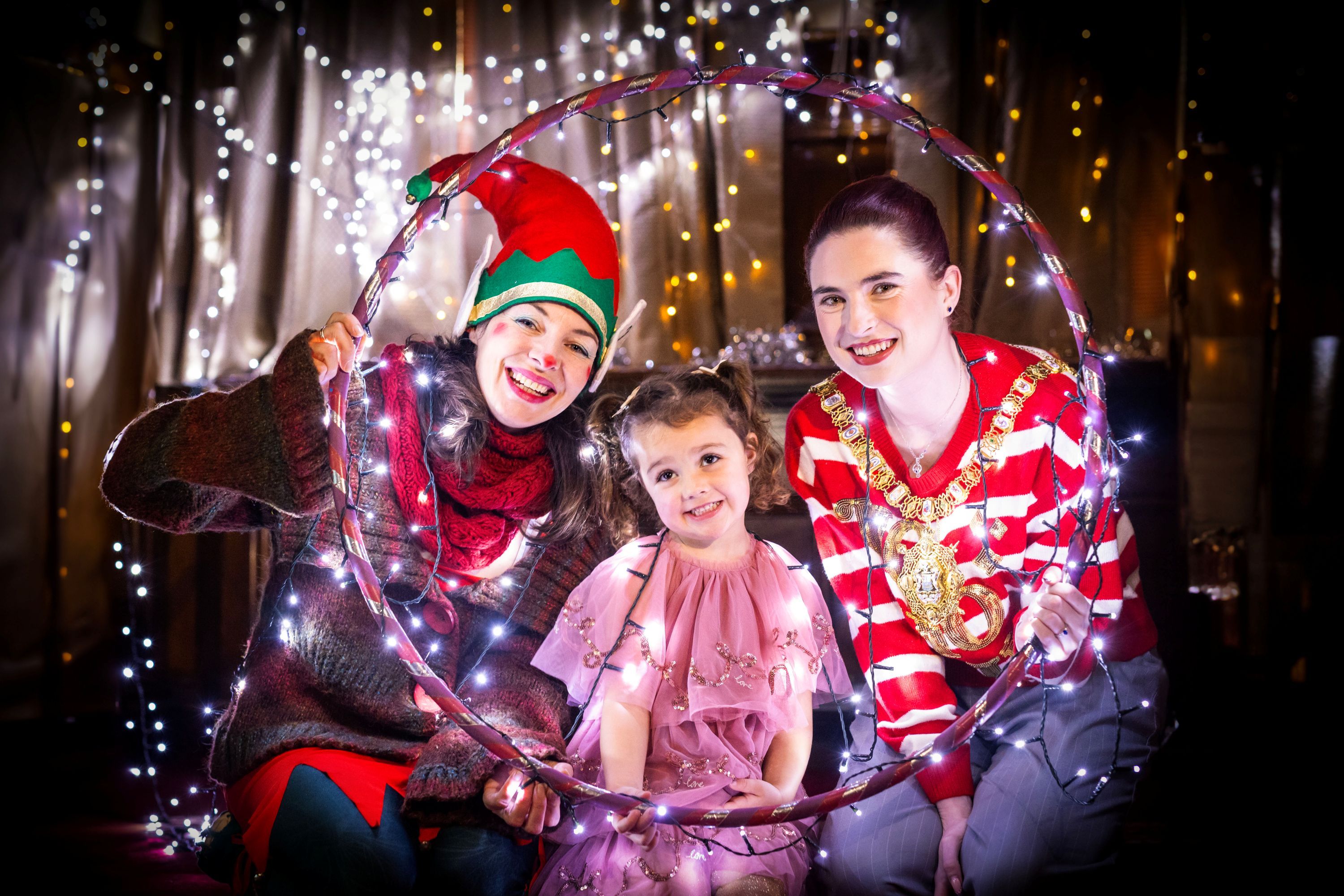Lord Mayor of Belfast, Councillor Róis-Máire Donnelly with Santa’s elf Candy Plum and youngster Farrah