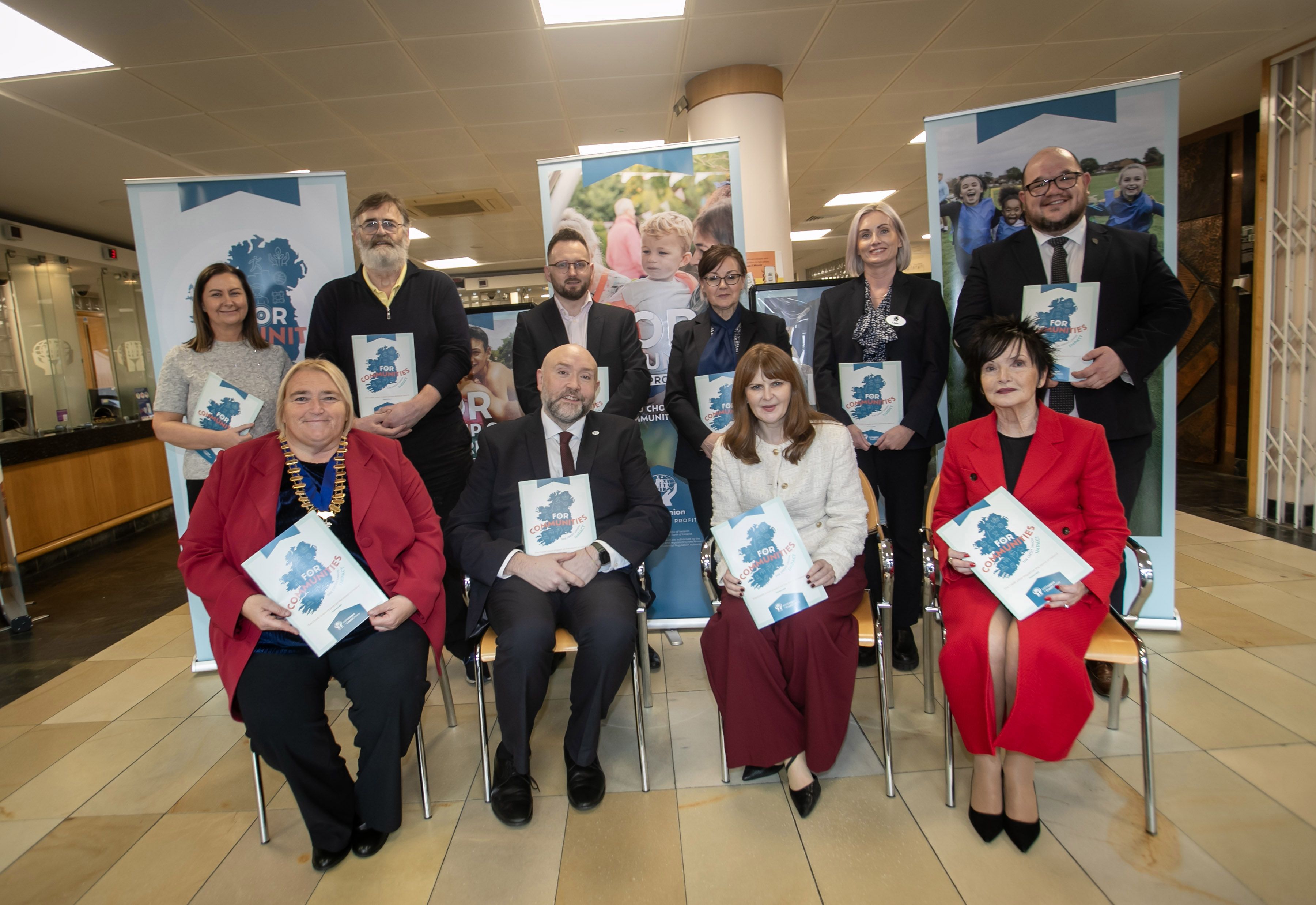 The Economy Minister Dr Caoimhe Archibald (front row, middle right) at Derry Credit Union for the launch of the Irish League of Credit Unions' First Community Impact Report for Credit Unions