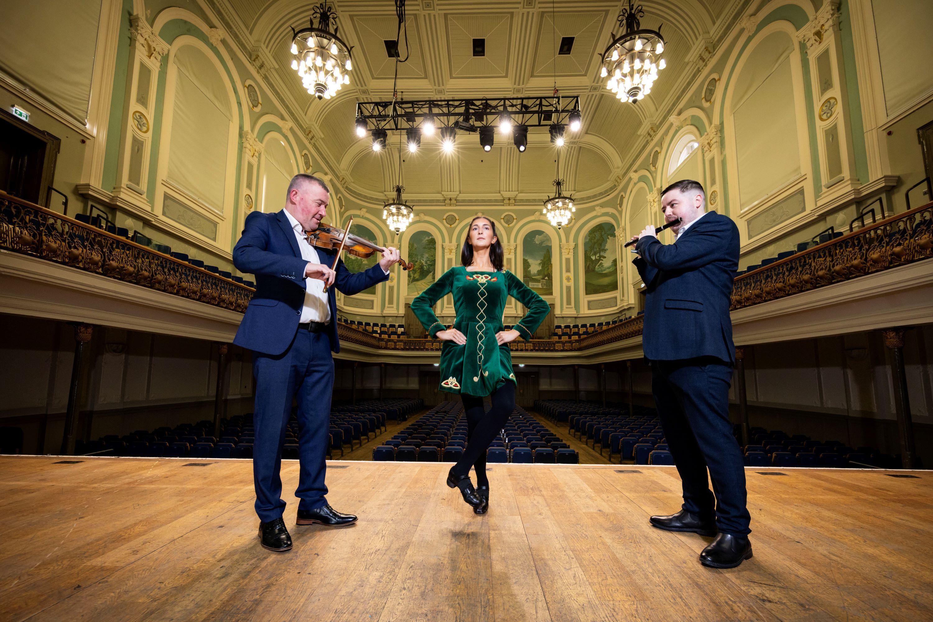 Niall McClean from Ards CCÉ and Darren Leighton from Belfast Bands Forum join dancer Olivia Reid to tune up for two years of Fleadh Cheoil in Belfast