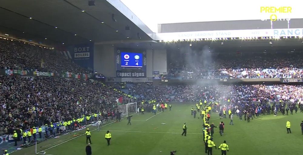 A PICTURE PAINTS A THOUSAND WORDS: The last of the Celtic fans leave the pitch as Rangers Ultras besiege police and stewards