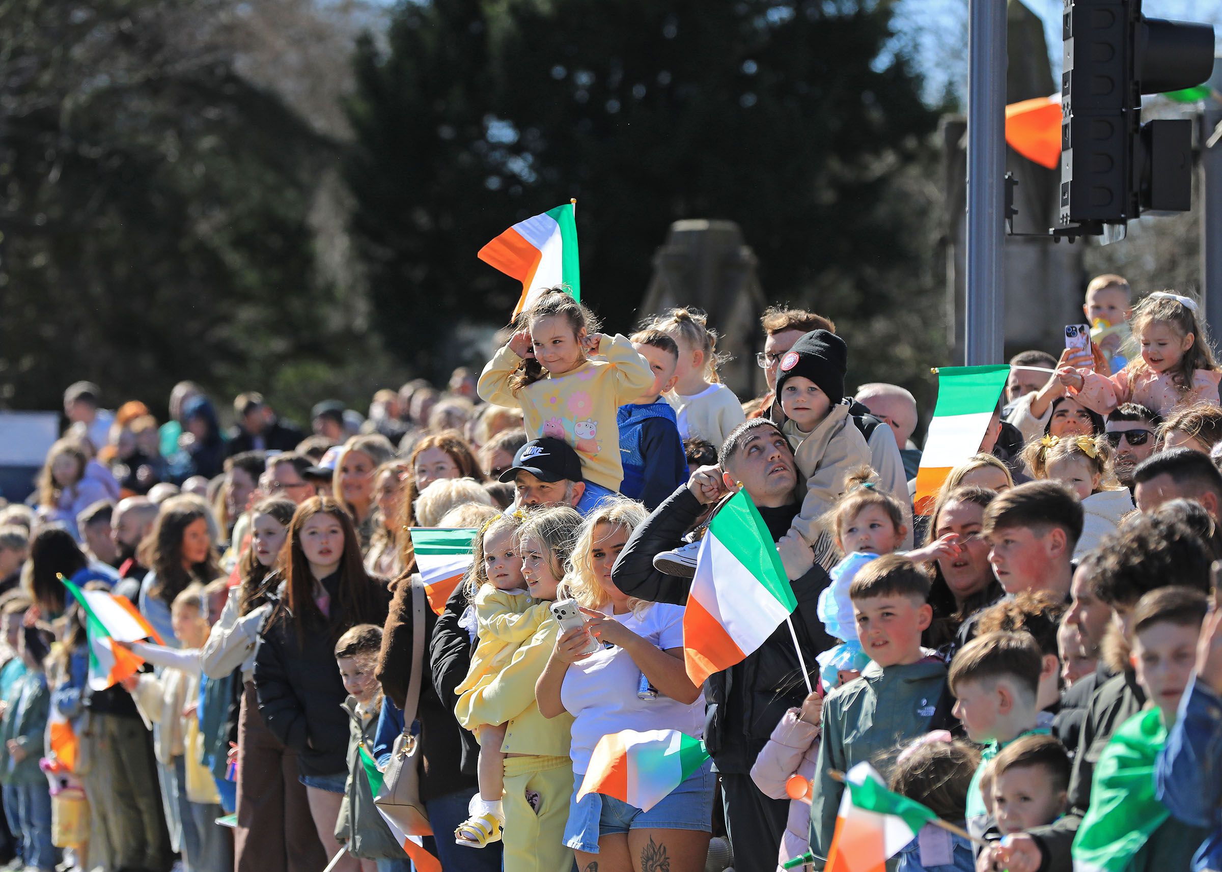FALLS FÁILTE: Crowds wait for the National Graves parade close to Milltown Cemetery