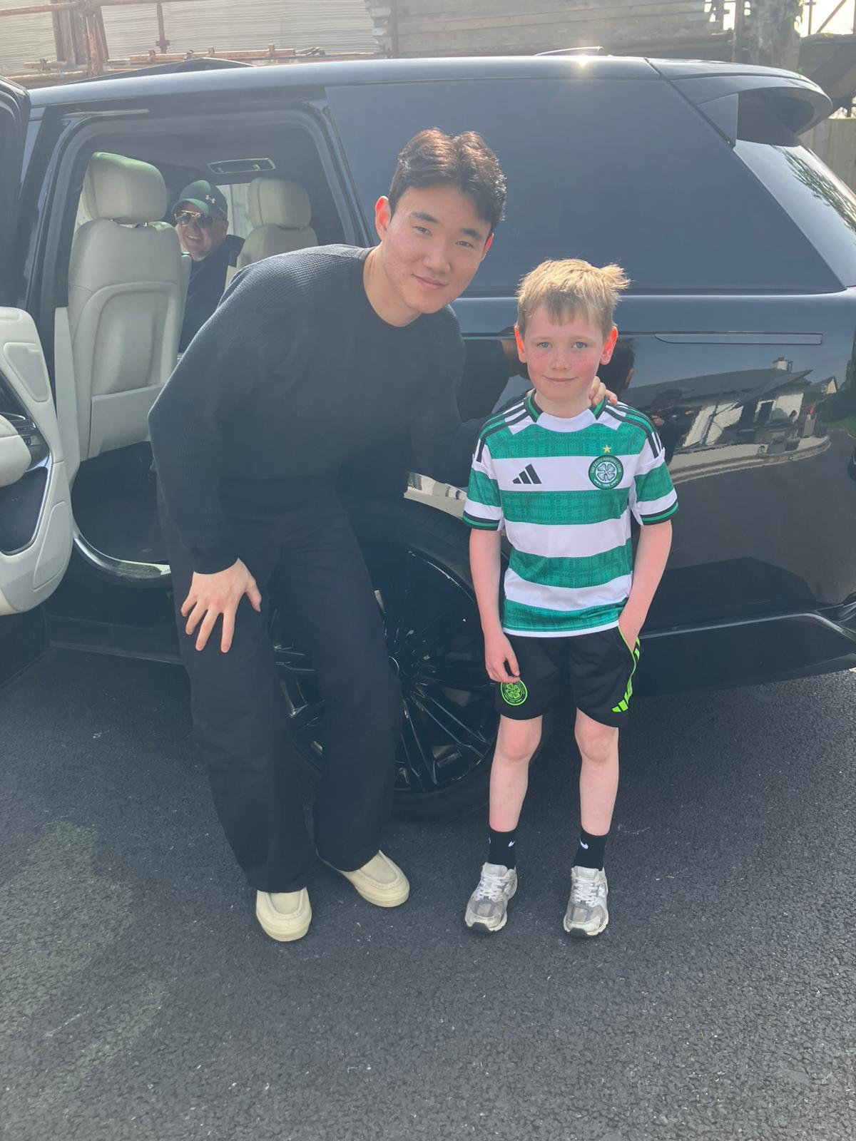 A delighted young Celtic fan has his photo taken with Yang
