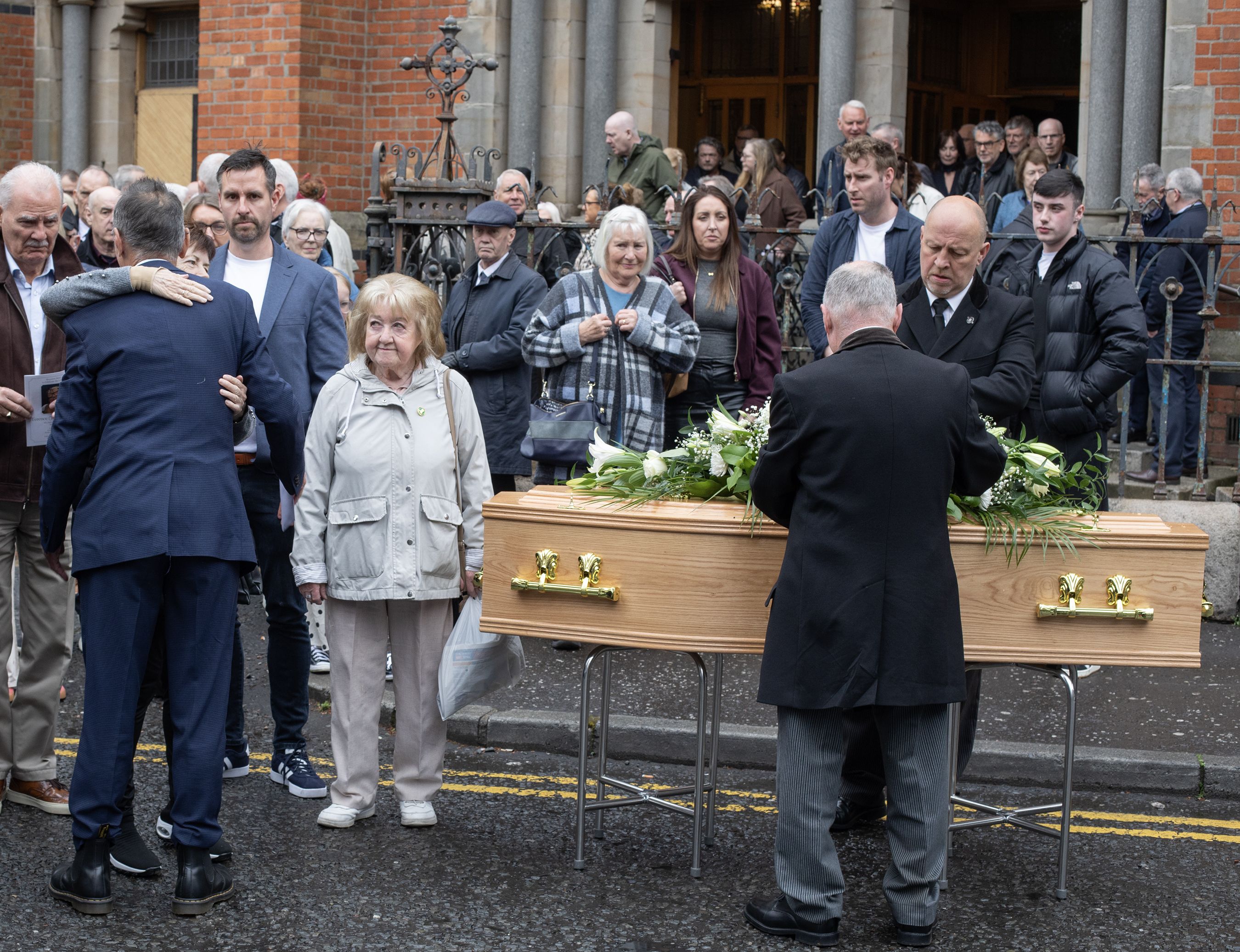Family members were consoled outside St Paul's this morning