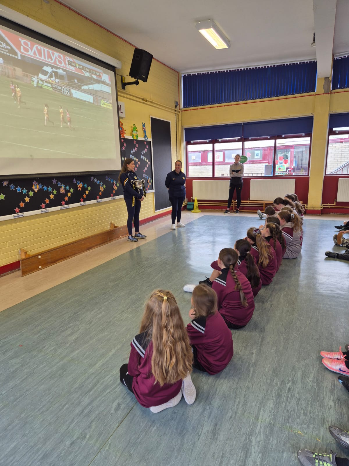 Dúana chatting with pupils whilst holding the trophy