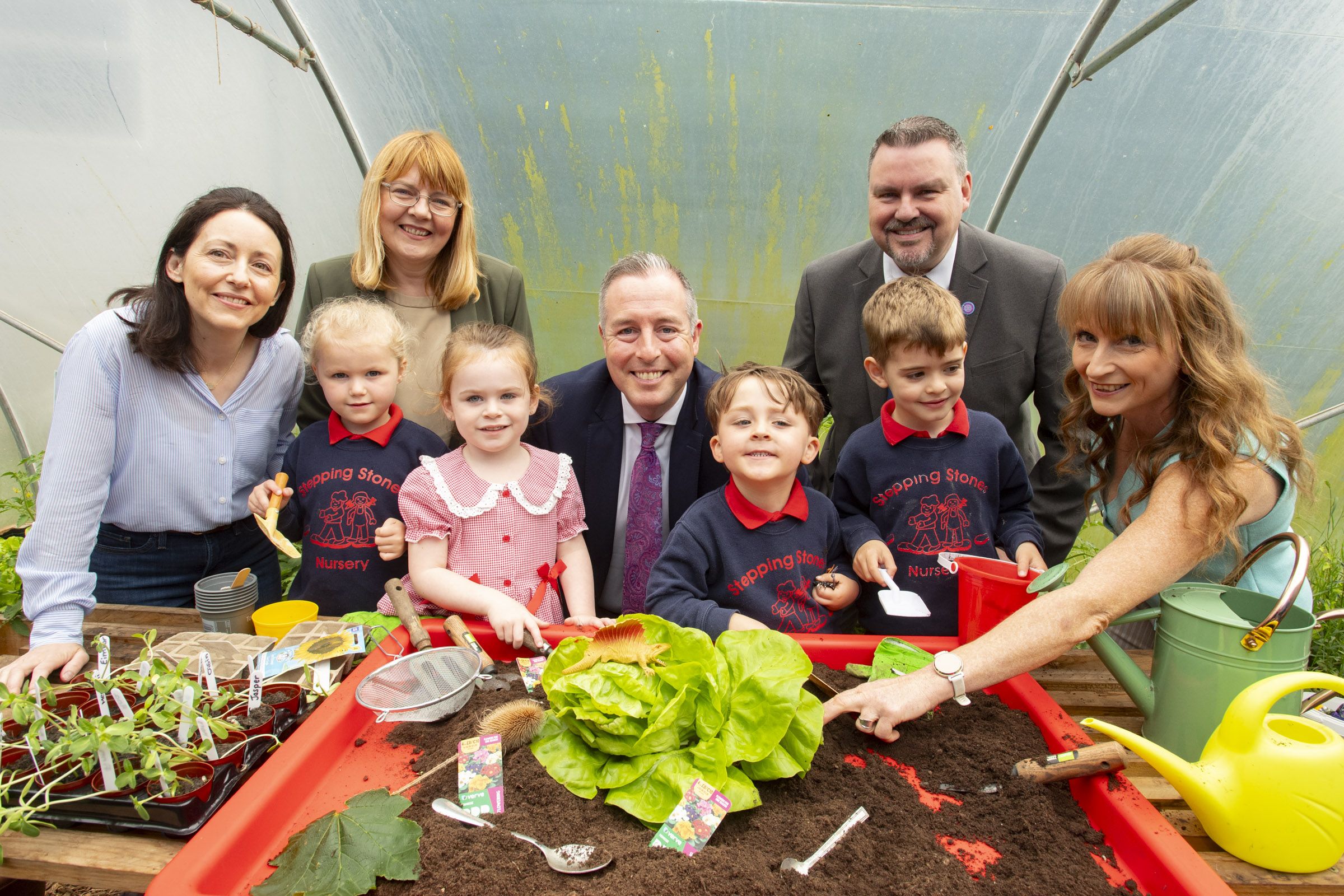 Edwina Weiniger (Stepping Stones Chairperson), Elaine Loughran (Principal Our Lady of Lourdes Primary School), Education Minister Paul Givan, Alan Herron (Playboard NI CEO) and Susan Williams (SEN Inclusive Play Project Coordinator, Playboard NI) with pupils