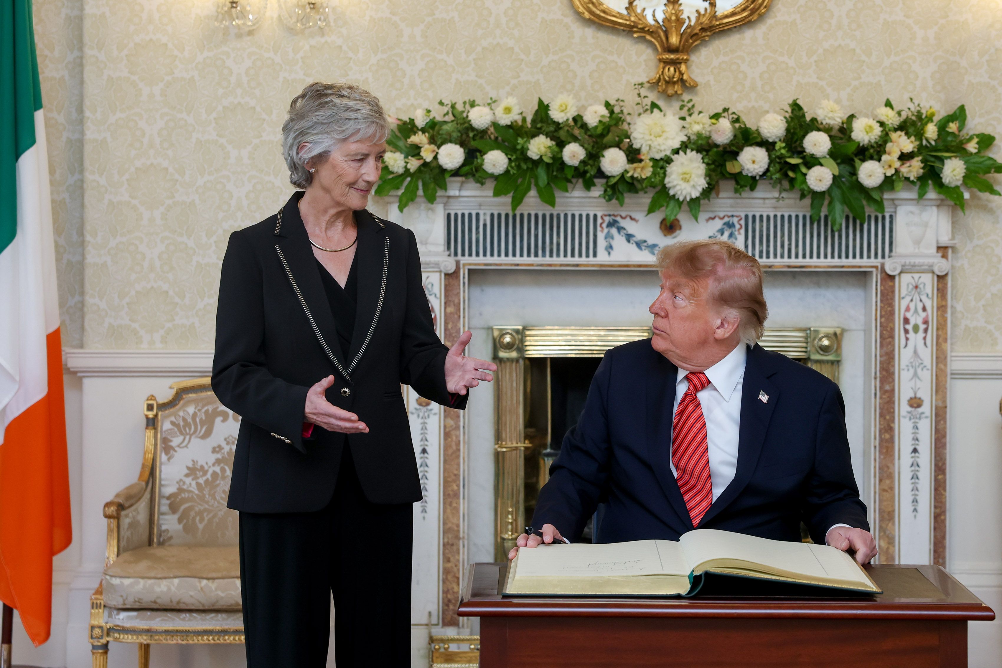 President Connolly alongside President Donald Trump as he signs the visitors book in Áras an Uachtaráin during a courtesy call at the start of his visit to Ireland. Pic Tony Maxwell - 12-9-26 via Rollingnews.ie