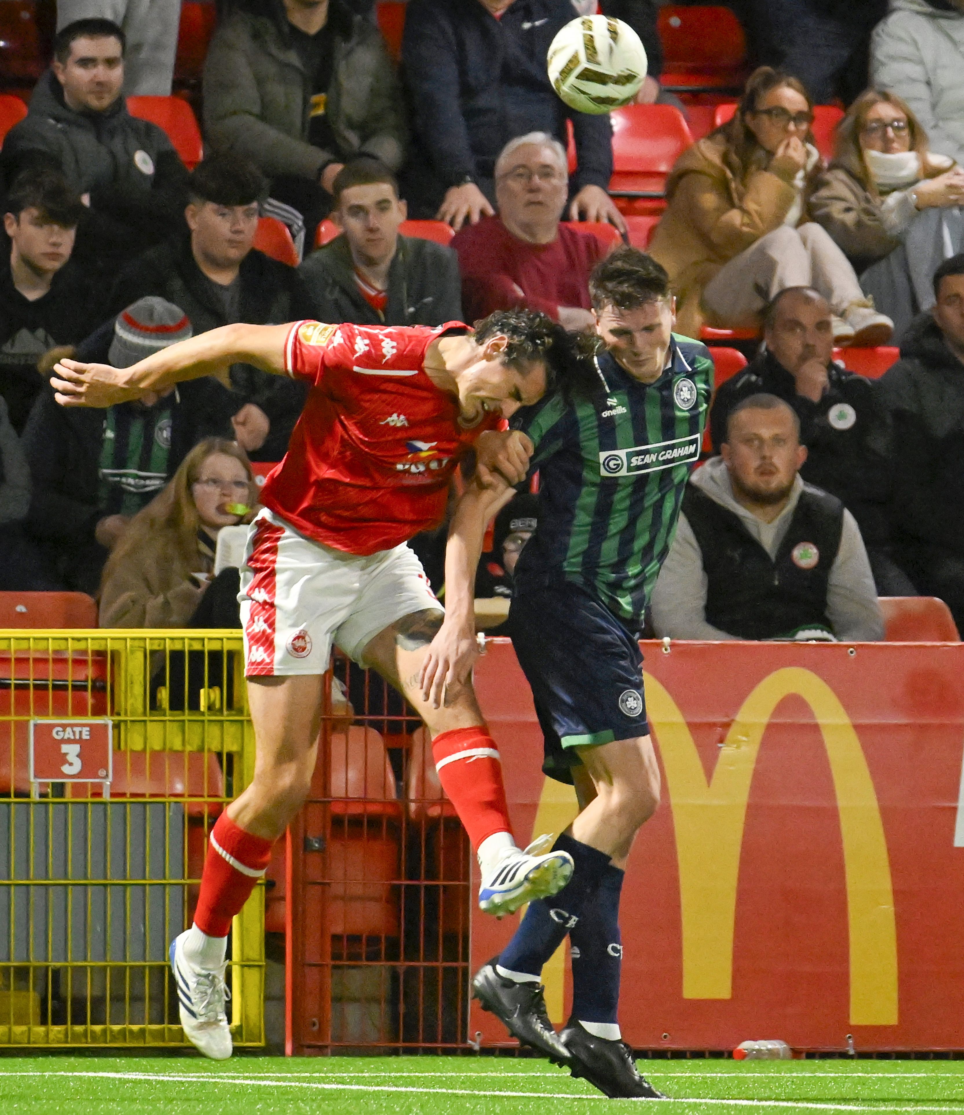 Larne’s Mathew Ridley with Cliftonville’s Shaun Leppard