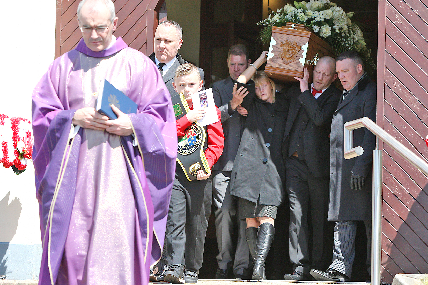 Eamonn Magee Snr and his wife Mary carry the coffin of their son, Eamonn Jnr, from St Joseph\'s Hannahstown, for burial in the adjacent cemetery. Leading the way is Parish Priest Father Kevin McGuckien