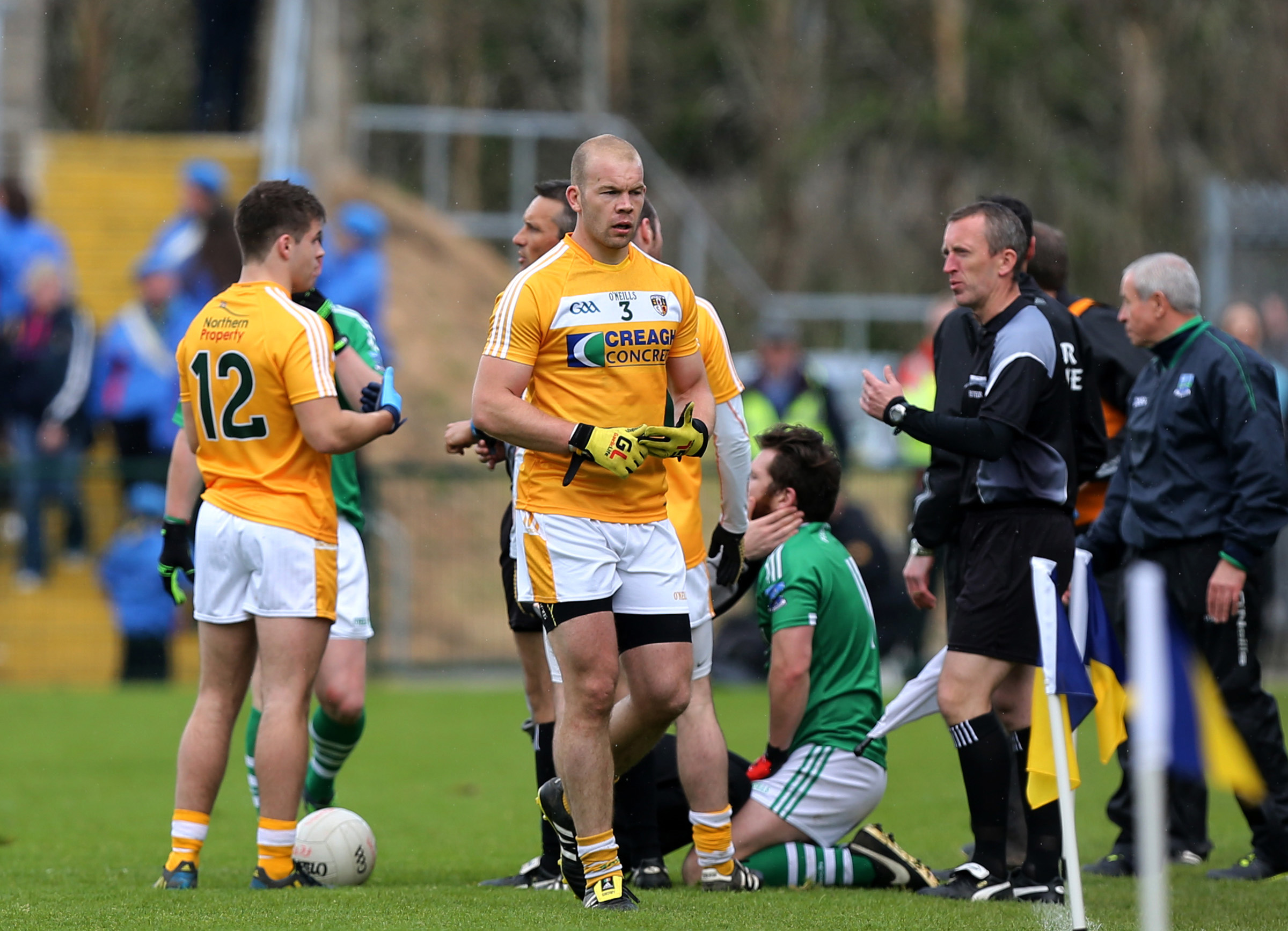Ciarán Flaherty receives attention as Sean McVeigh makes the long walk after his 31st minute red card